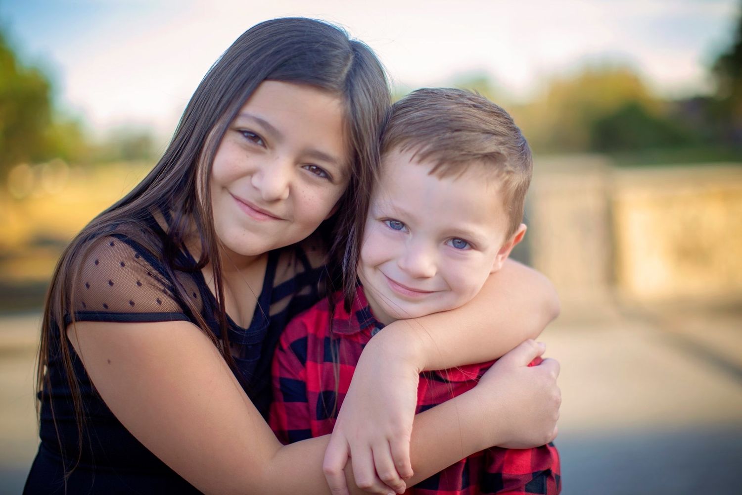 A series of intimate family portraits showing tender moments between loved ones in outdoor settings.