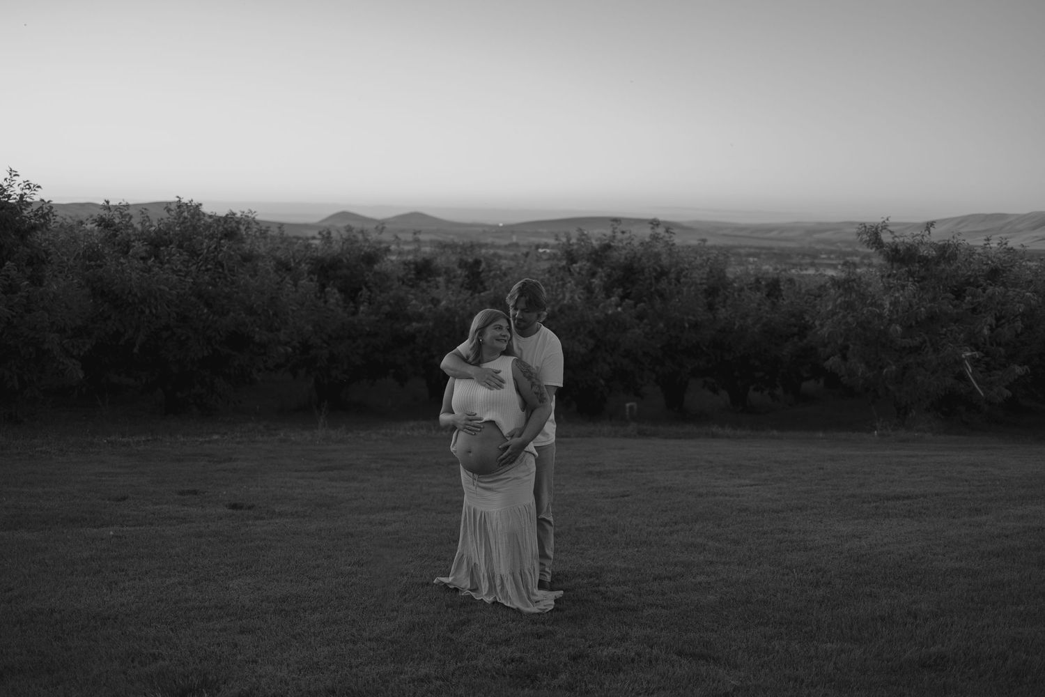 Monochrome panoramic views of rolling countryside landscapes with silhouettes of people relaxing in nature.