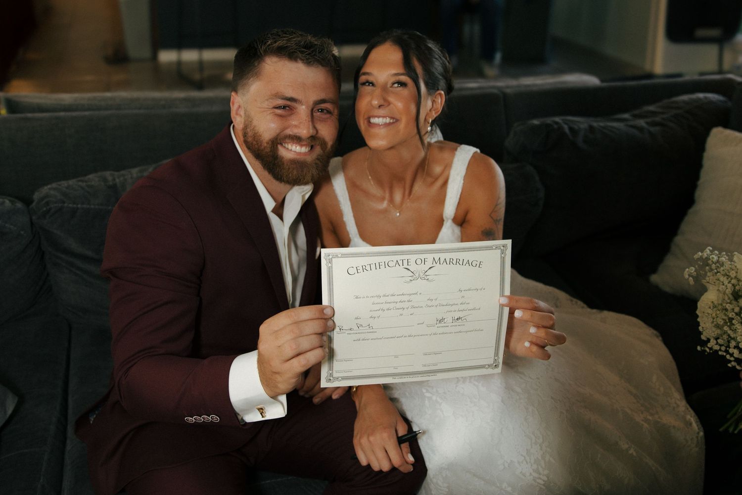 A happy couple holding their marriage certificate after getting married at city hall.