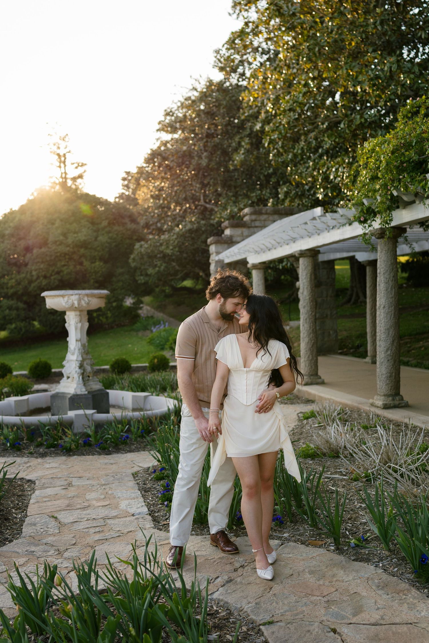 Engaged couple embrace in the Italian Garden at Maymont Park in Richmond, Virginia
