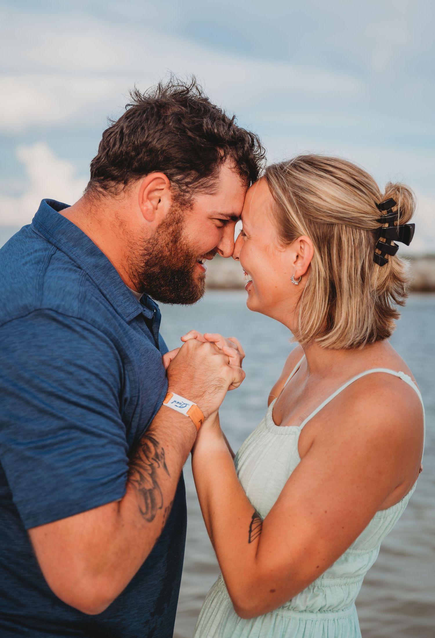 A romantic couple shares tender moments together on a beach at sunset in a series of intimate portraits in Panama City Beach.