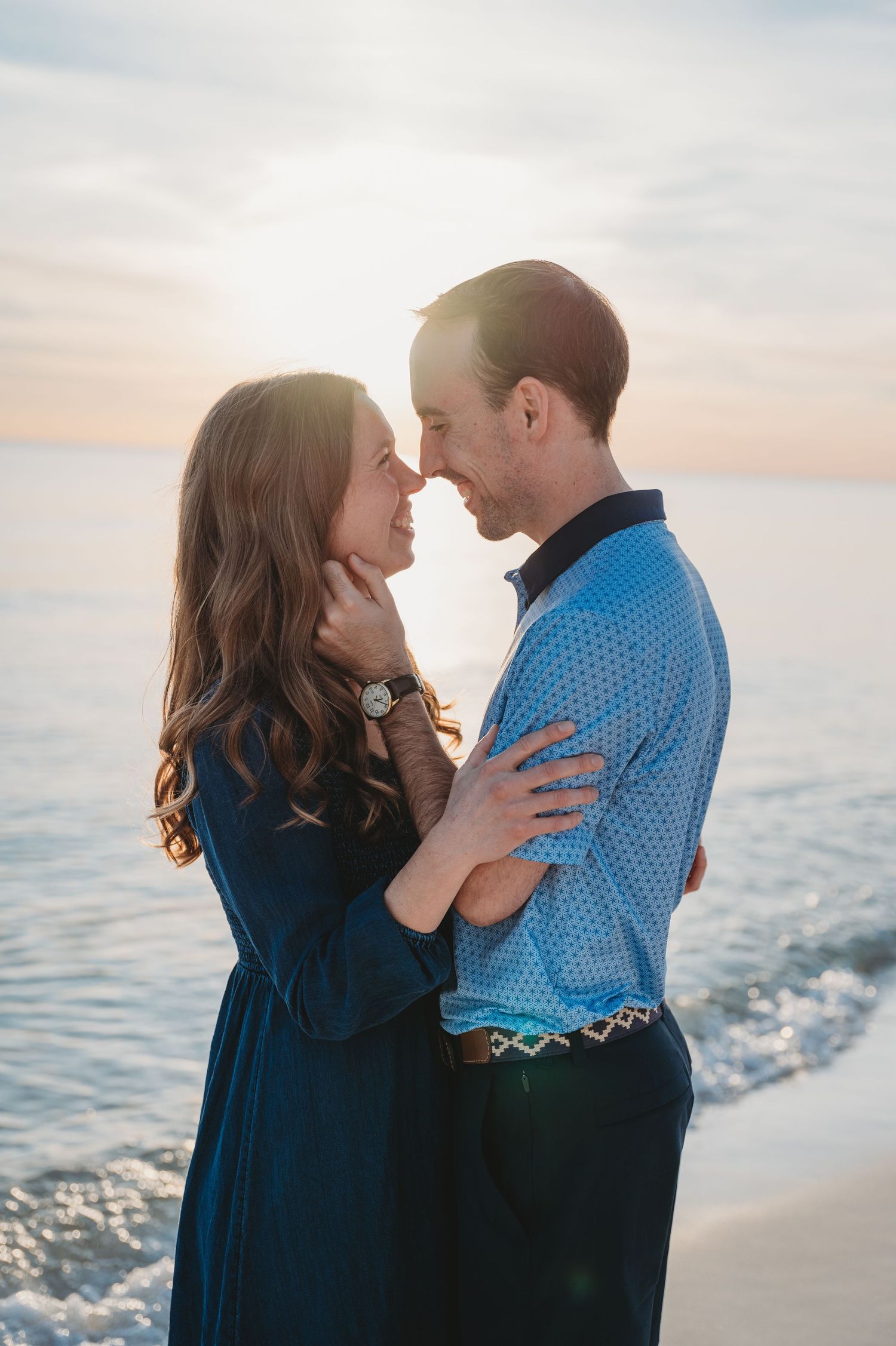 A romantic couple embraces by the ocean at sunset in a series of tender moments in Panama City Beach.