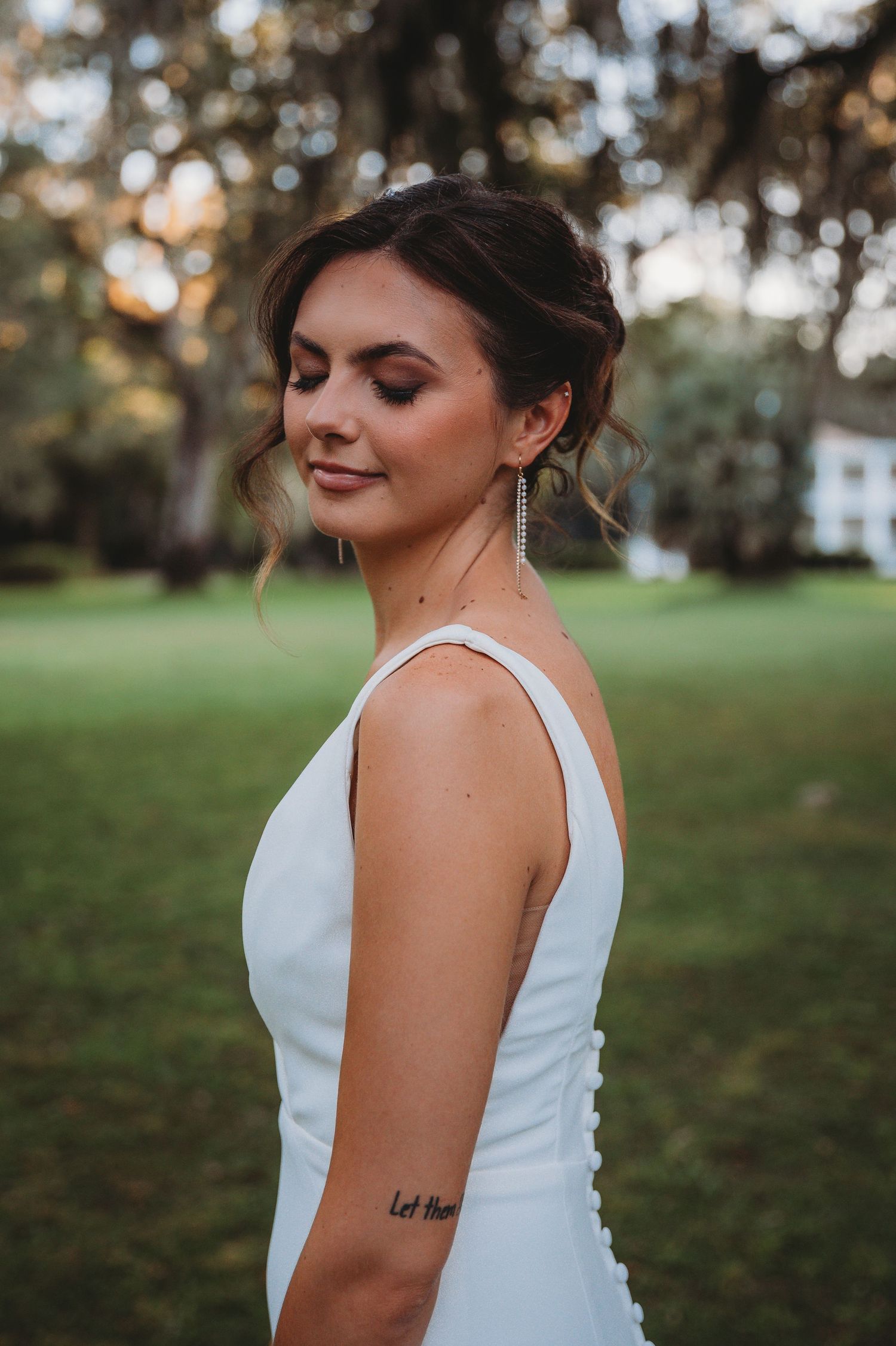Close-up portrait of bride in white dress with elegant updo hairstyle during a Panama City Beach wedding.