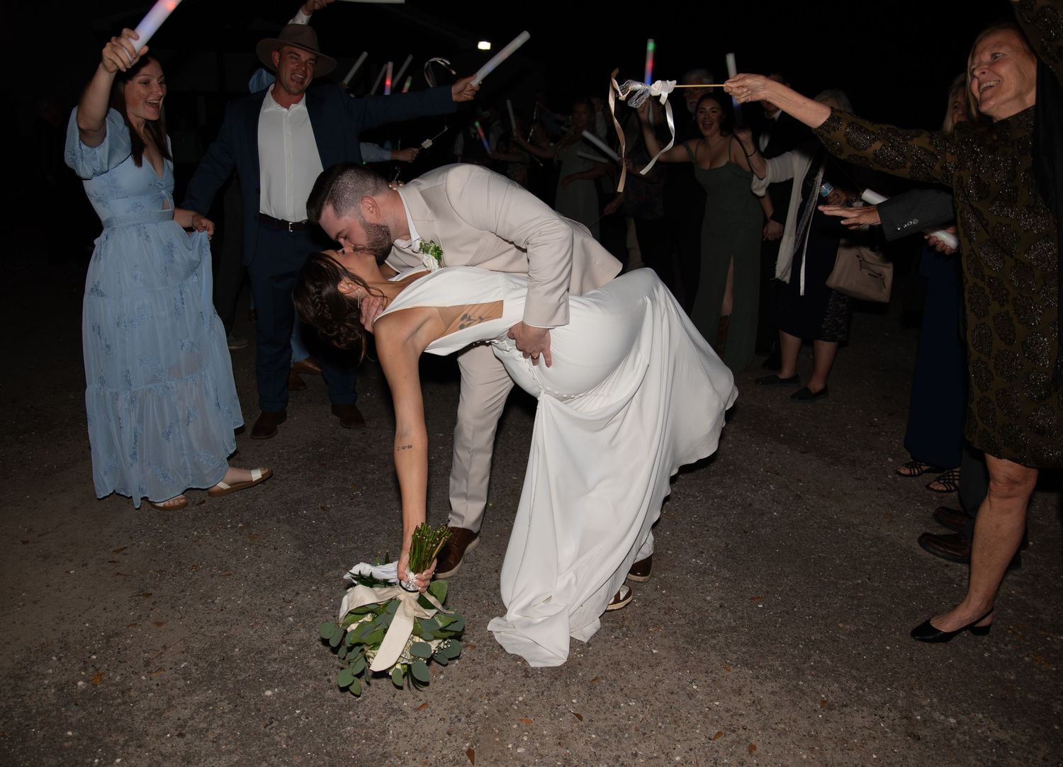 The bride and groom sharing a kiss during a wedding exit during a Panama City Beach wedding.