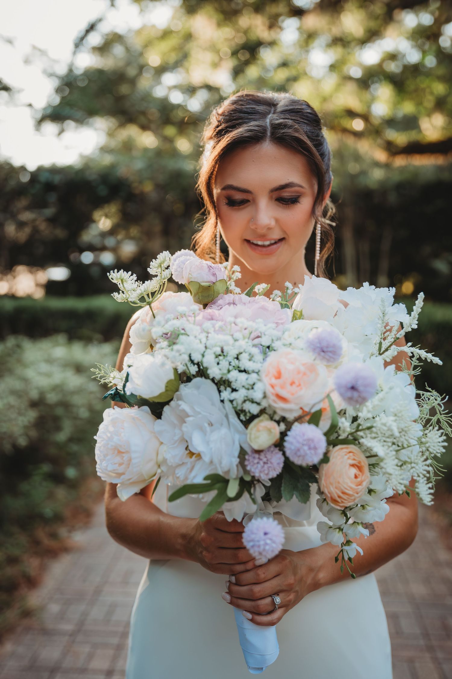 Elegant wedding bouquet featuring soft pink peonies, purple scabiosa, and white flowers during a Panama City Beach wedding.