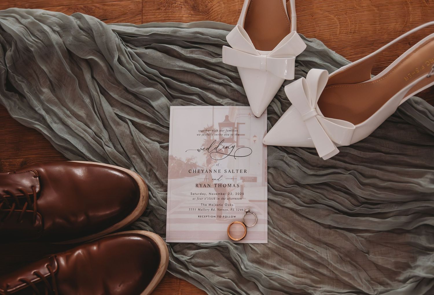 Brown leather dress shoes and gray fabric create an elegant composition for wedding detail photography.