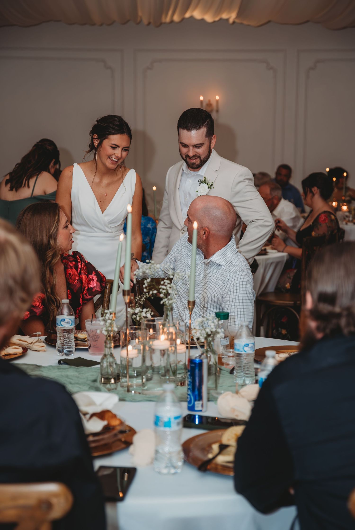 Wedding reception guests enjoying dinner and conversation at elegantly decorated tables during a Panama City Beach wedding.