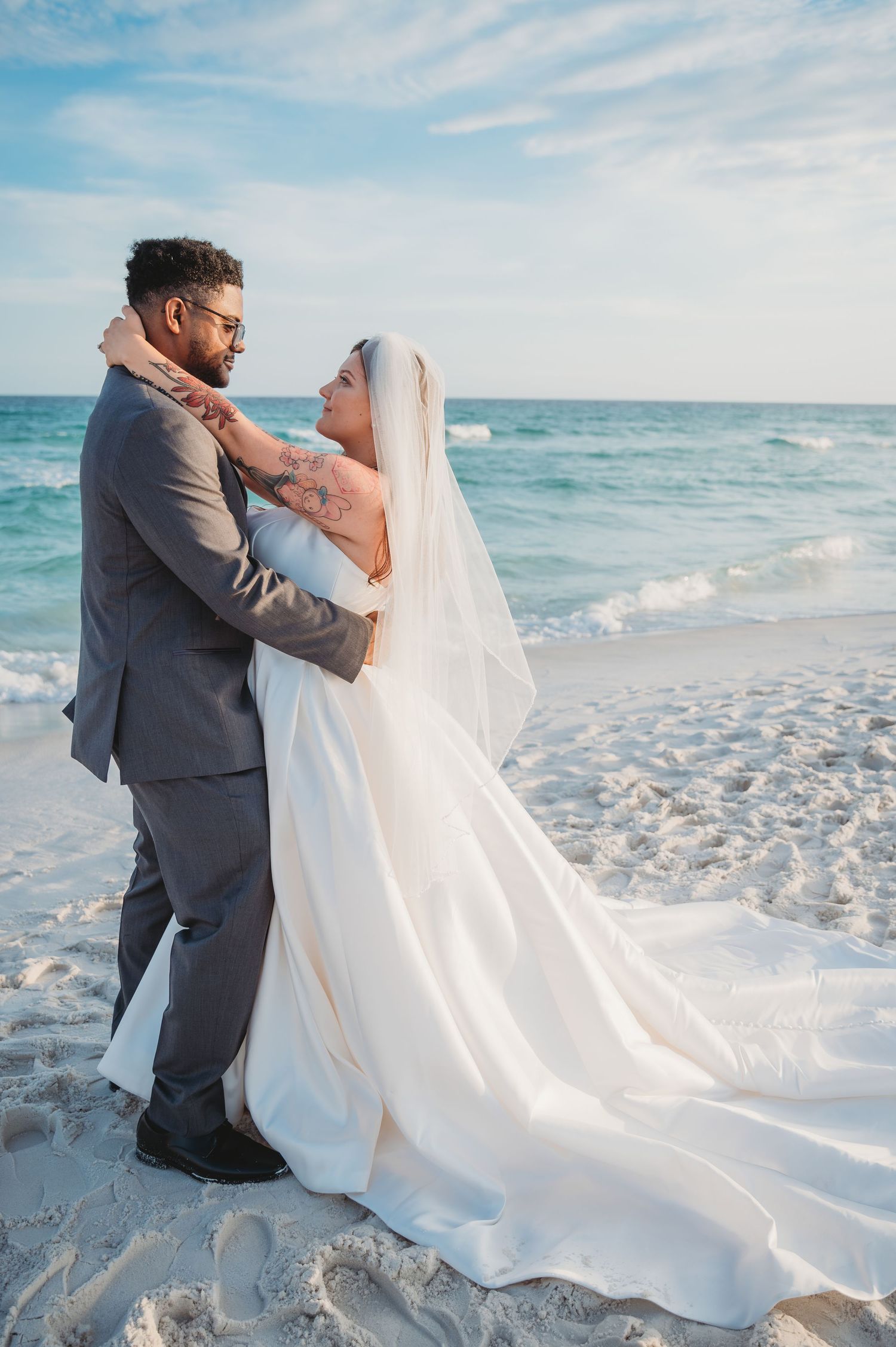 30A wedding bride and groom embrace on the beach.