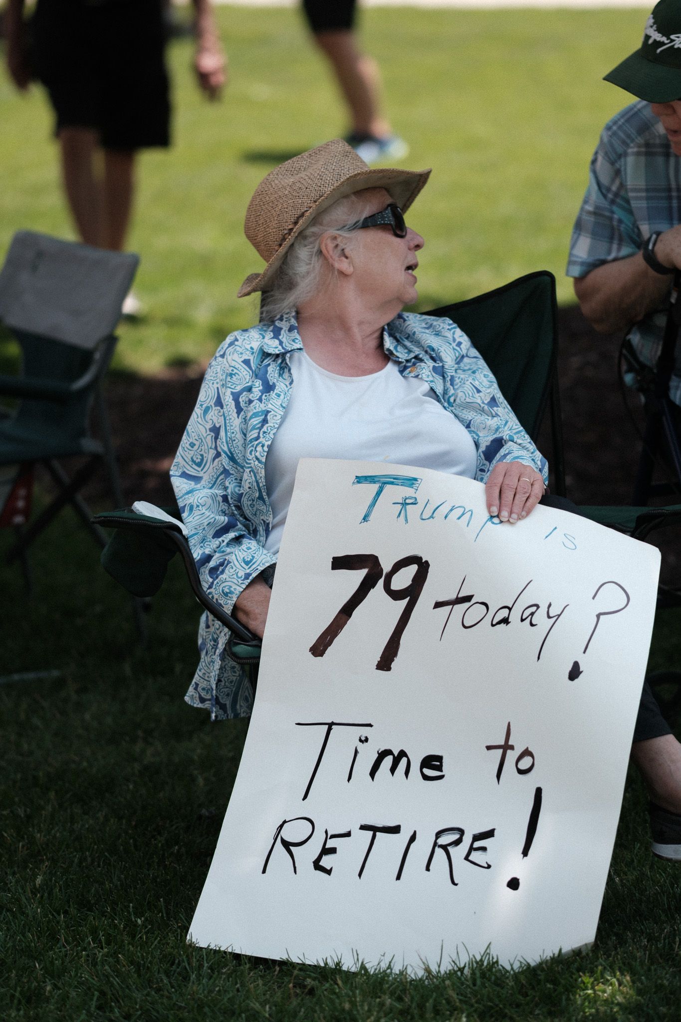 Protest signs arranged in sequence showing messages about retirement and time-related statements.