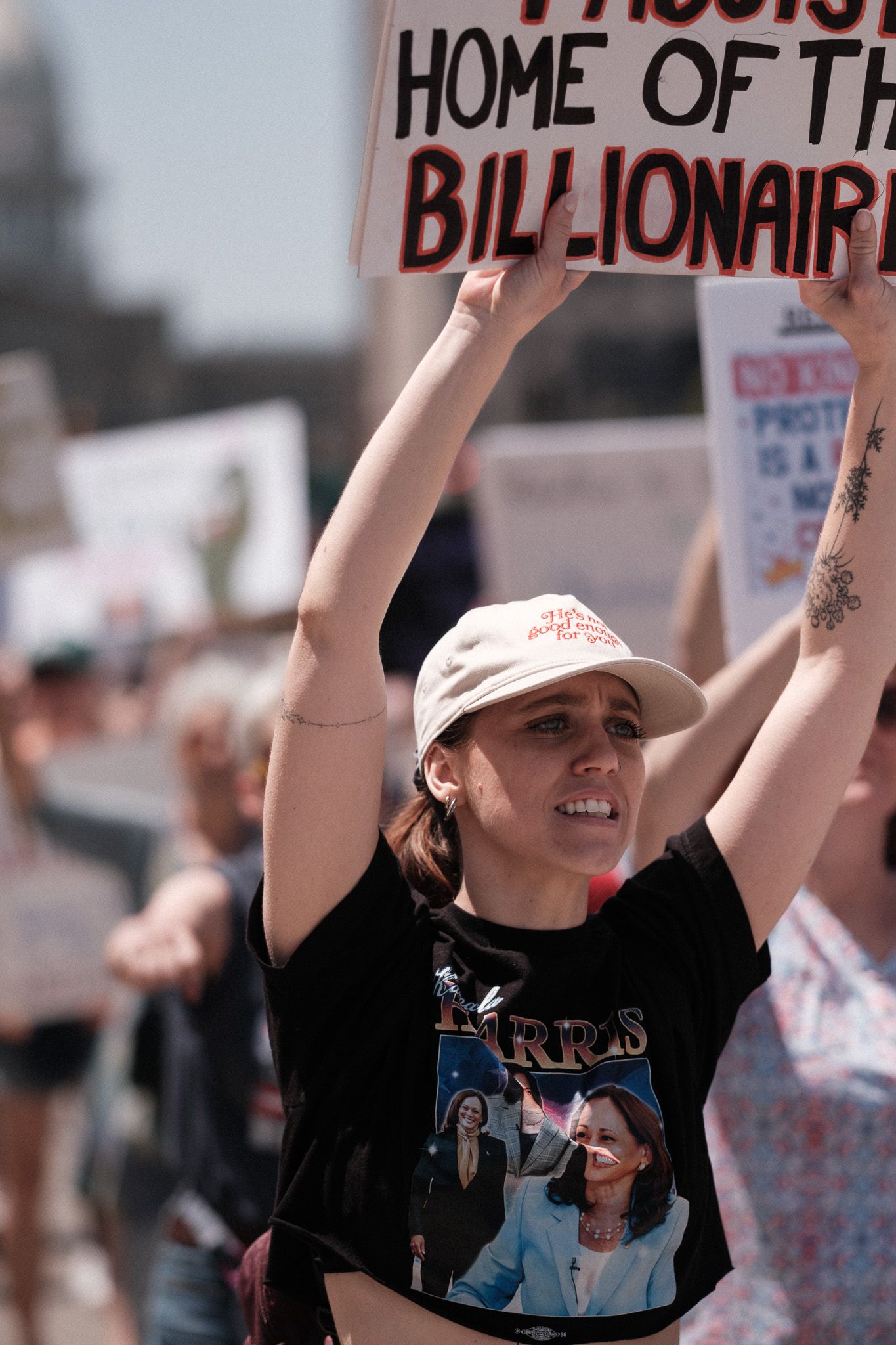 Group of protesters holding signs at an outdoor demonstration against billionaires.