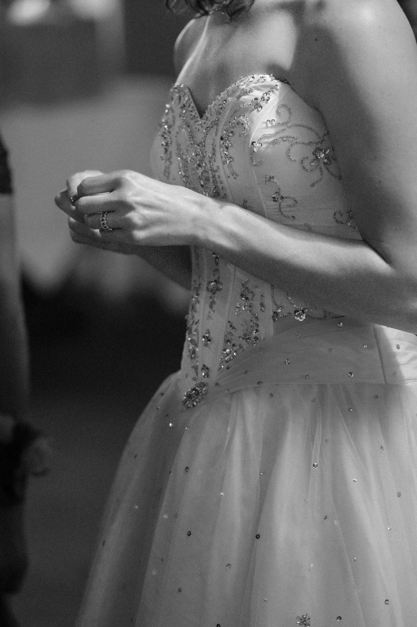 A series of elegant white flowing dresses with sparkly embellishments shown in a grayscale fashion sequence.