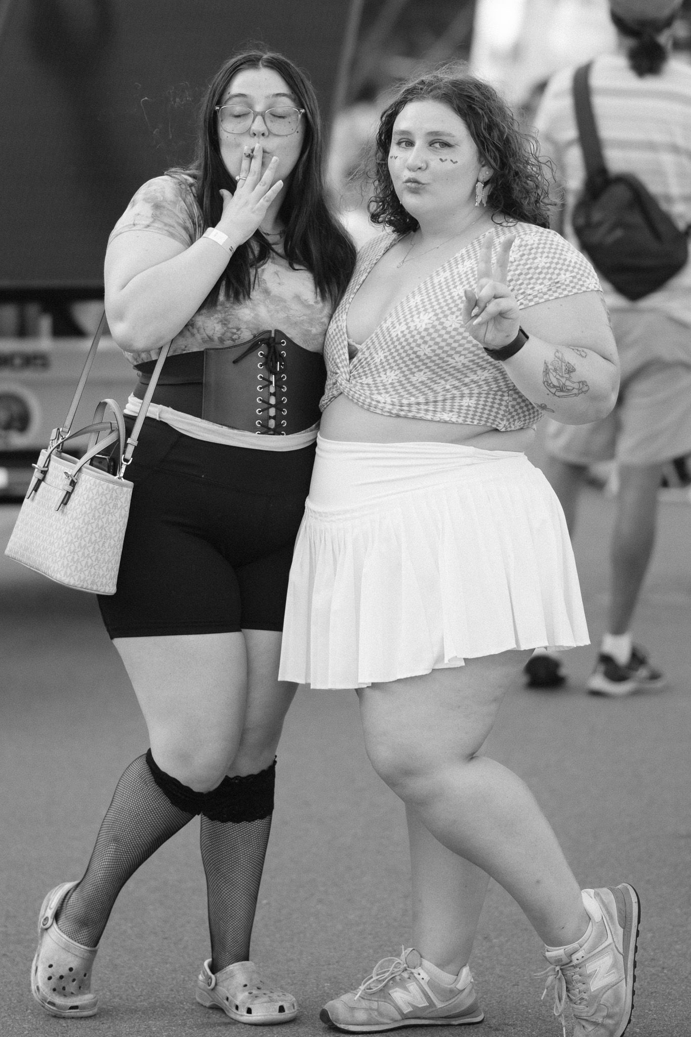 Group dancing and posing in casual summer outfits at an outdoor event.