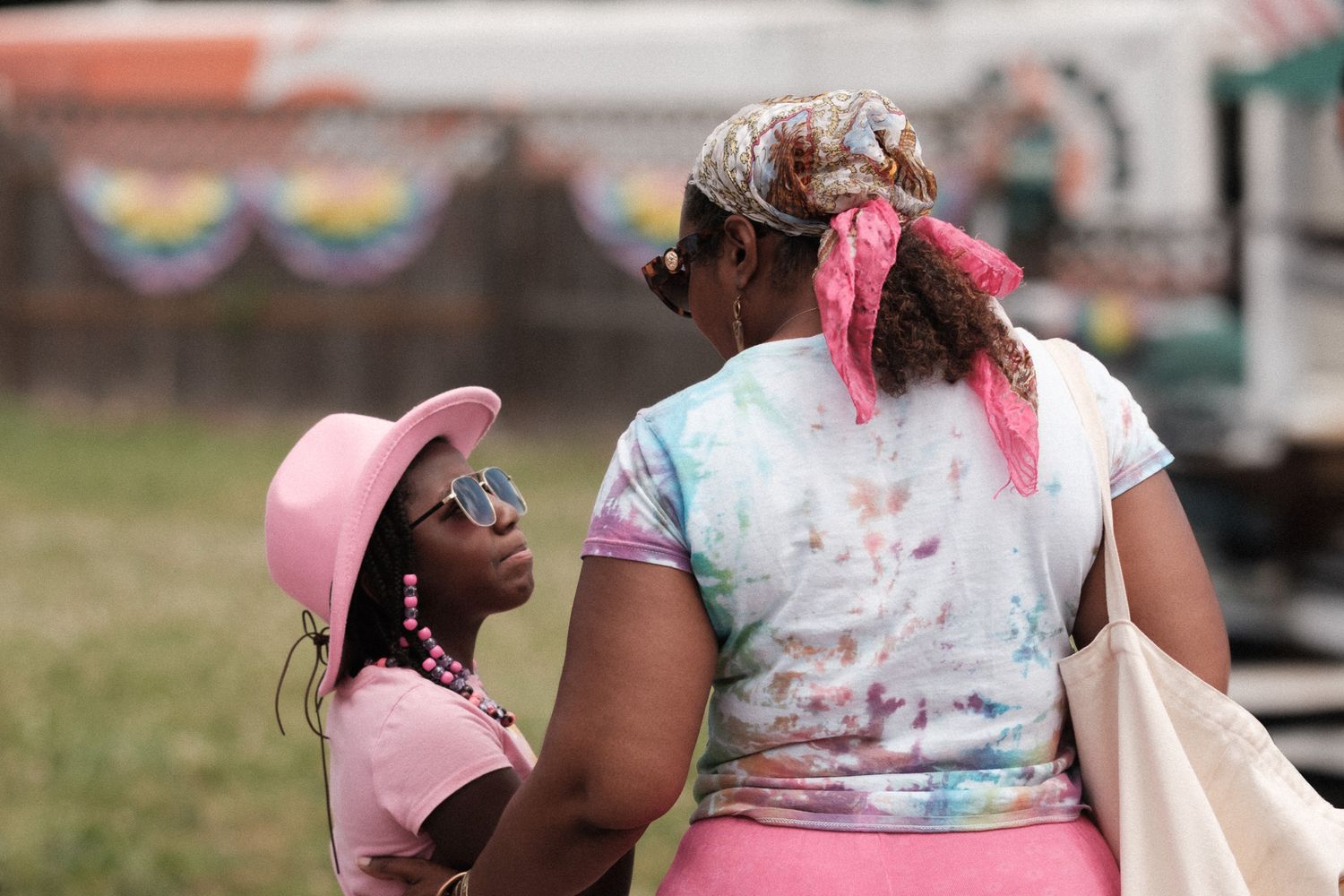 Festival attendees covered in colorful powder during outdoor celebration.
