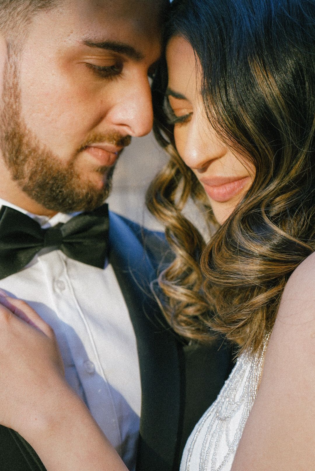 Romantic couple in formal attire sharing an intimate moment together.