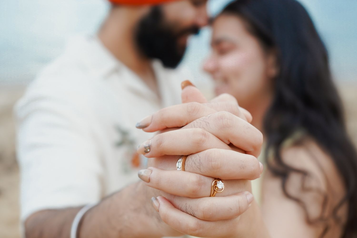 Close-up shots of hands holding and exchanging rings during a romantic wedding ceremony.