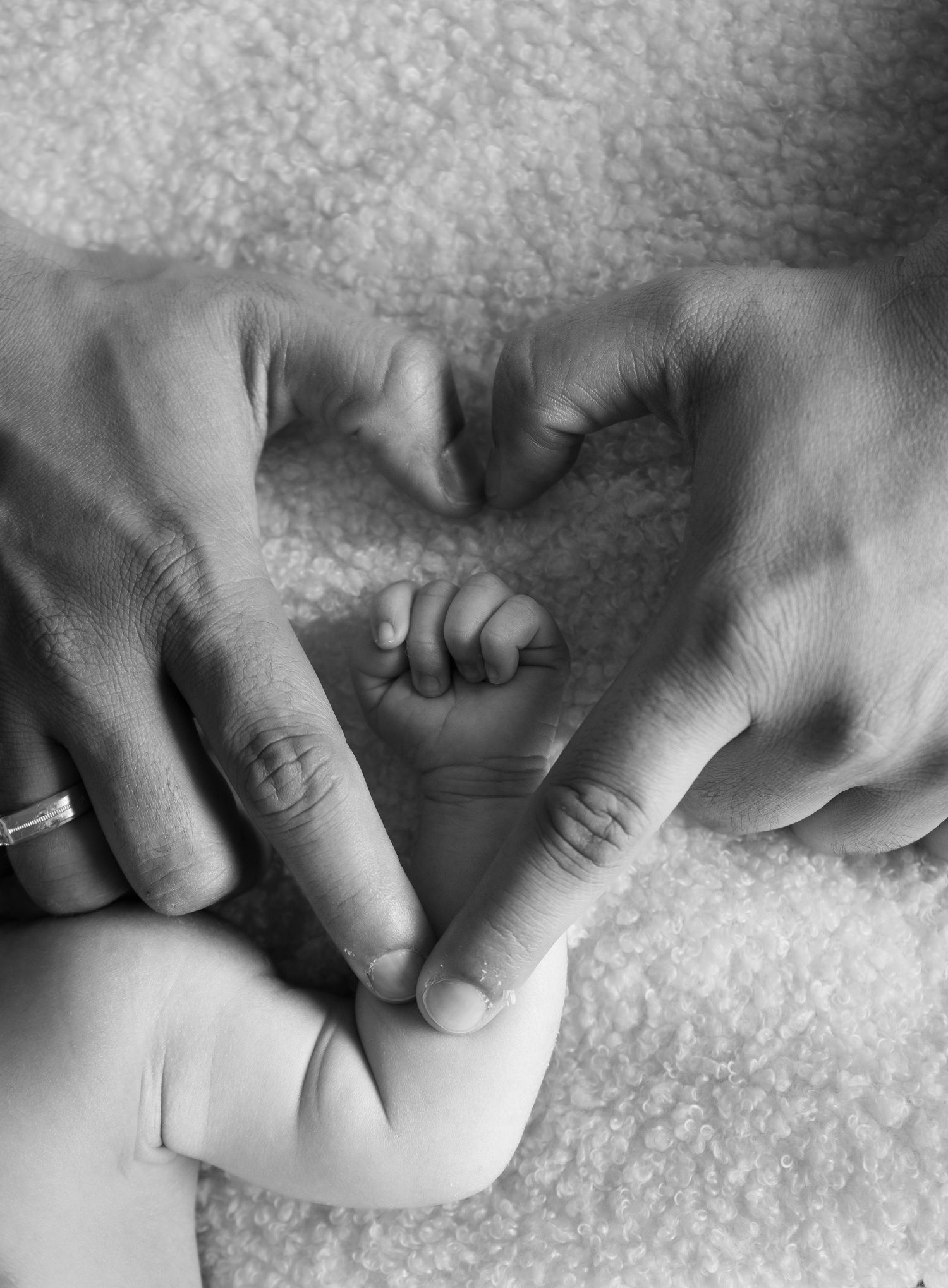 A series of black and white close-up photographs showing hands massaging and kneading bread dough on a textured surface.