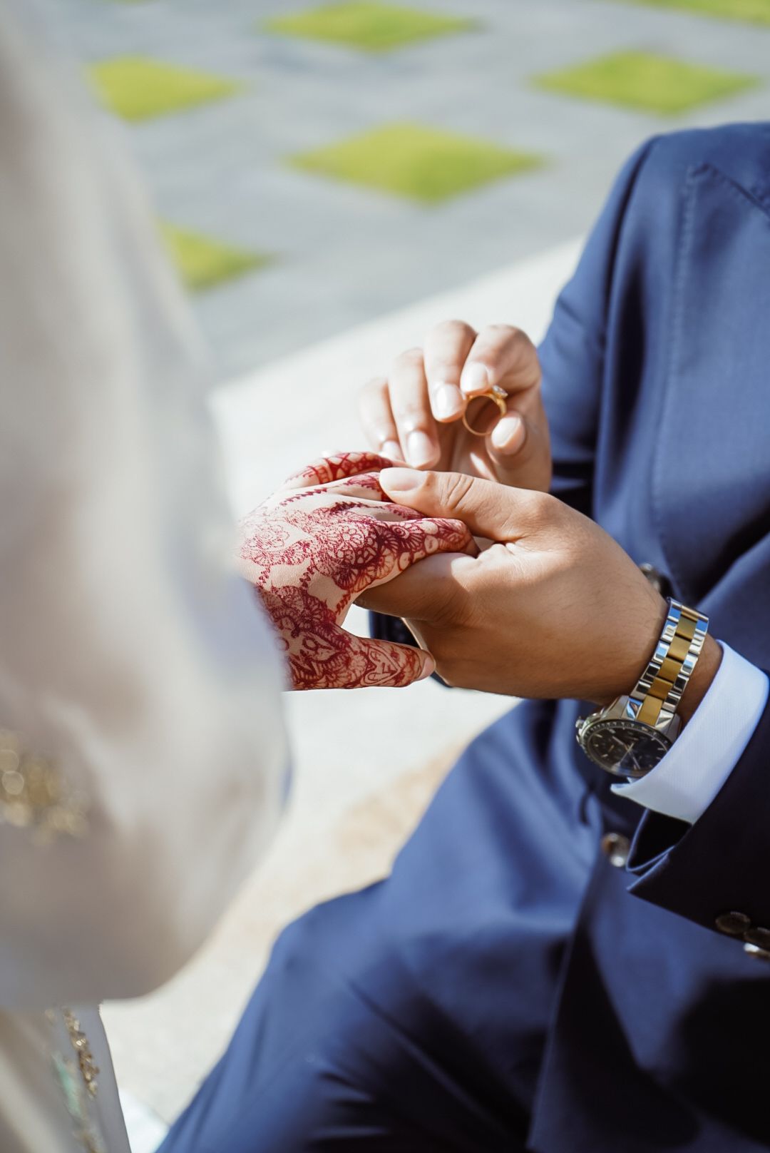 Close-up of hands exchanging rings during a traditional wedding ceremony.