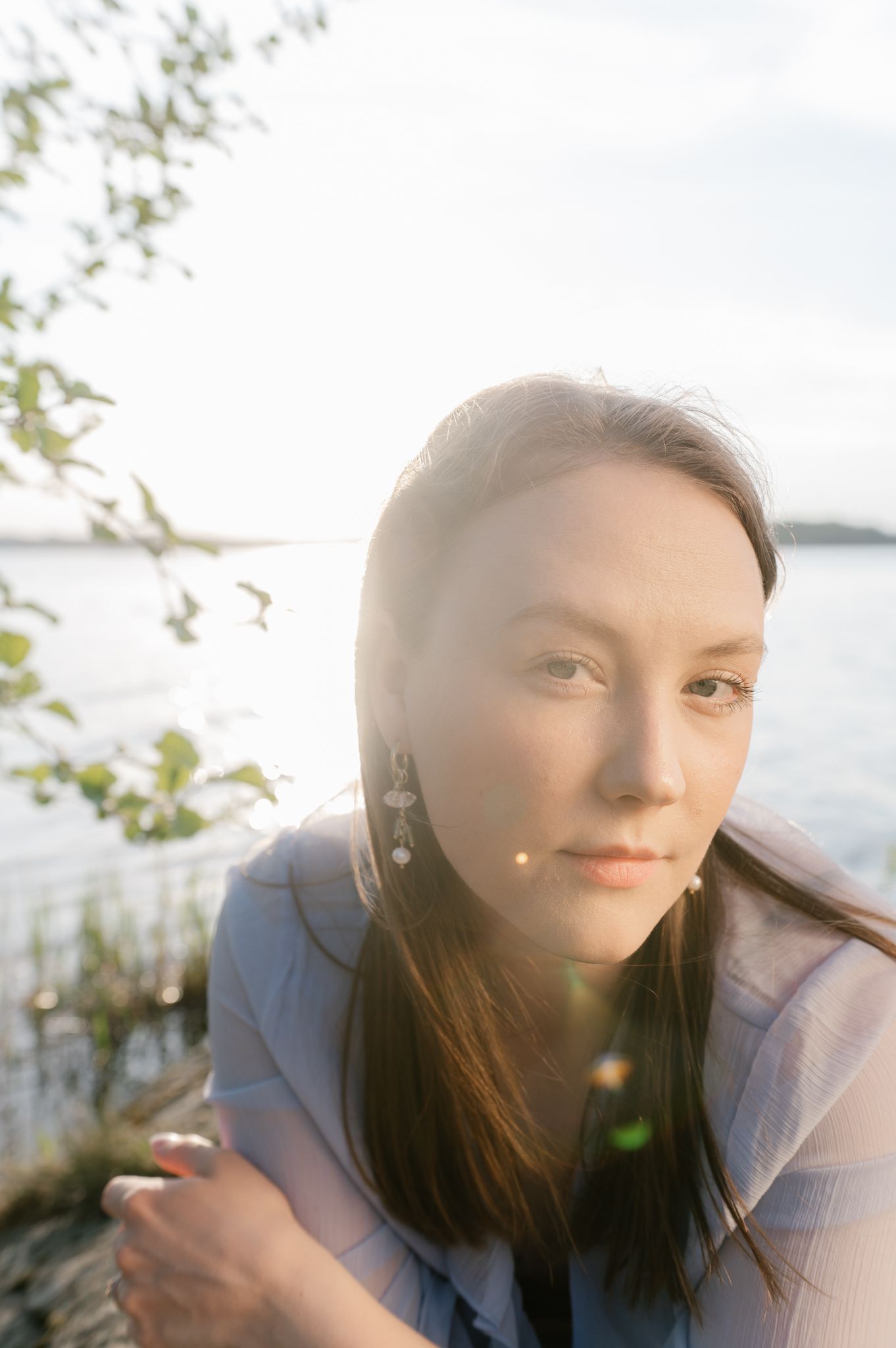 A soft sunlit portrait sequence shows someone with long dark hair gazing pensively outdoors.