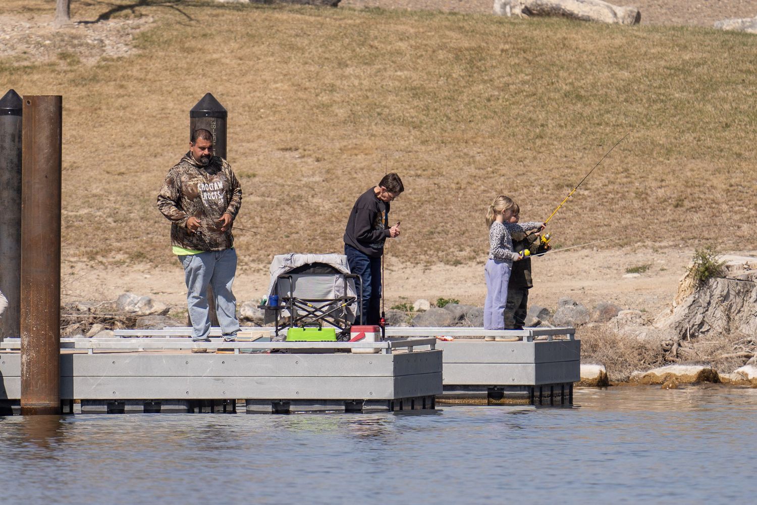 Anglers fishing from a dock during the Crappie Classic at C.J. Strike Reservoir in Idaho