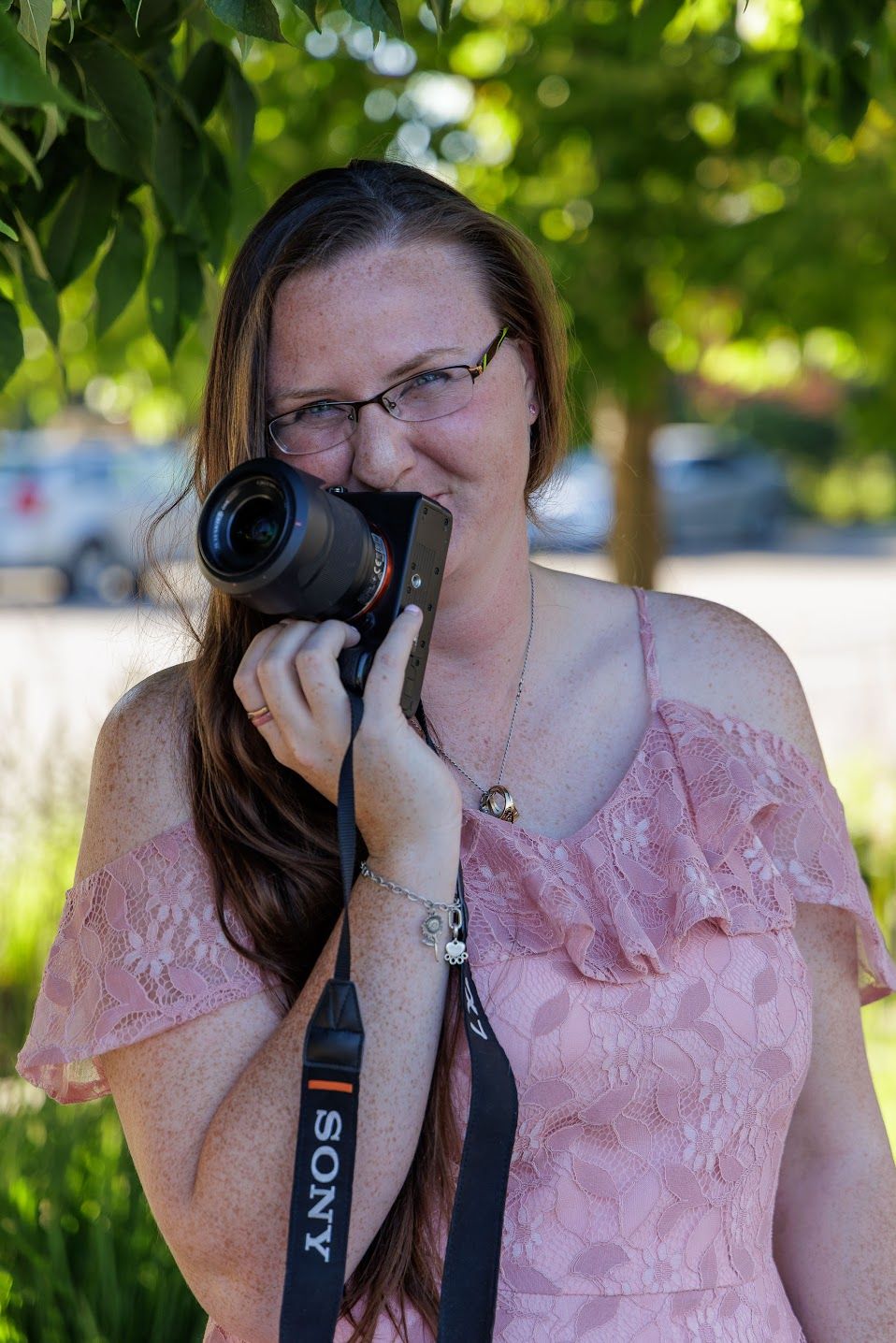 Carlleen of Double C Photography holding her camera during a branding session in Idaho