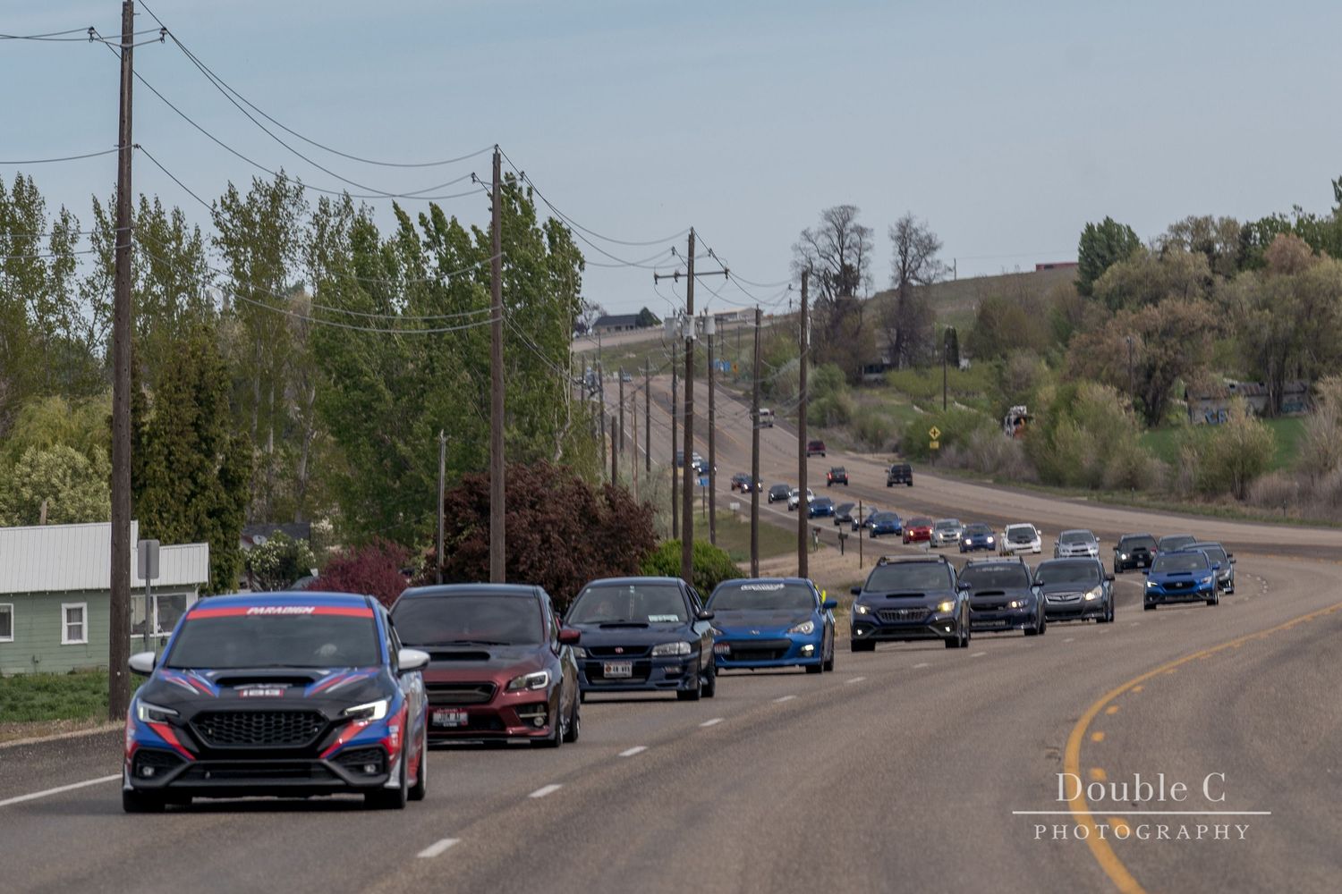 Line of Subaru vehicles traveling together during an Idaho Subaru Club cruise