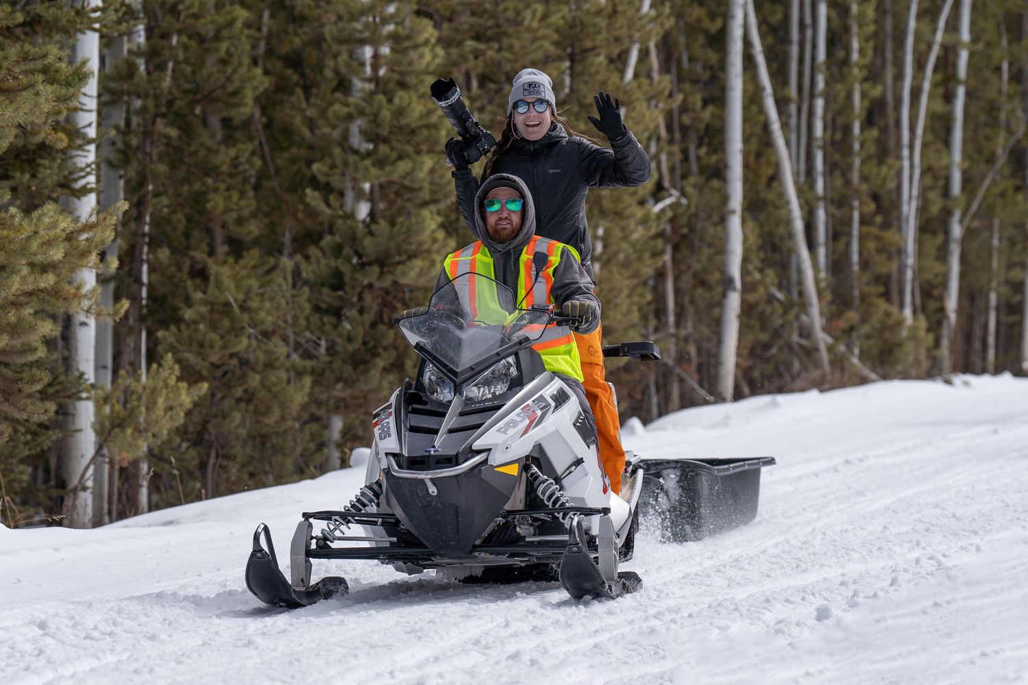 Snowmobiler and photographer traveling a snowy trail during the Utah Uinta Ultimate 15-mile sled dog race in Idaho