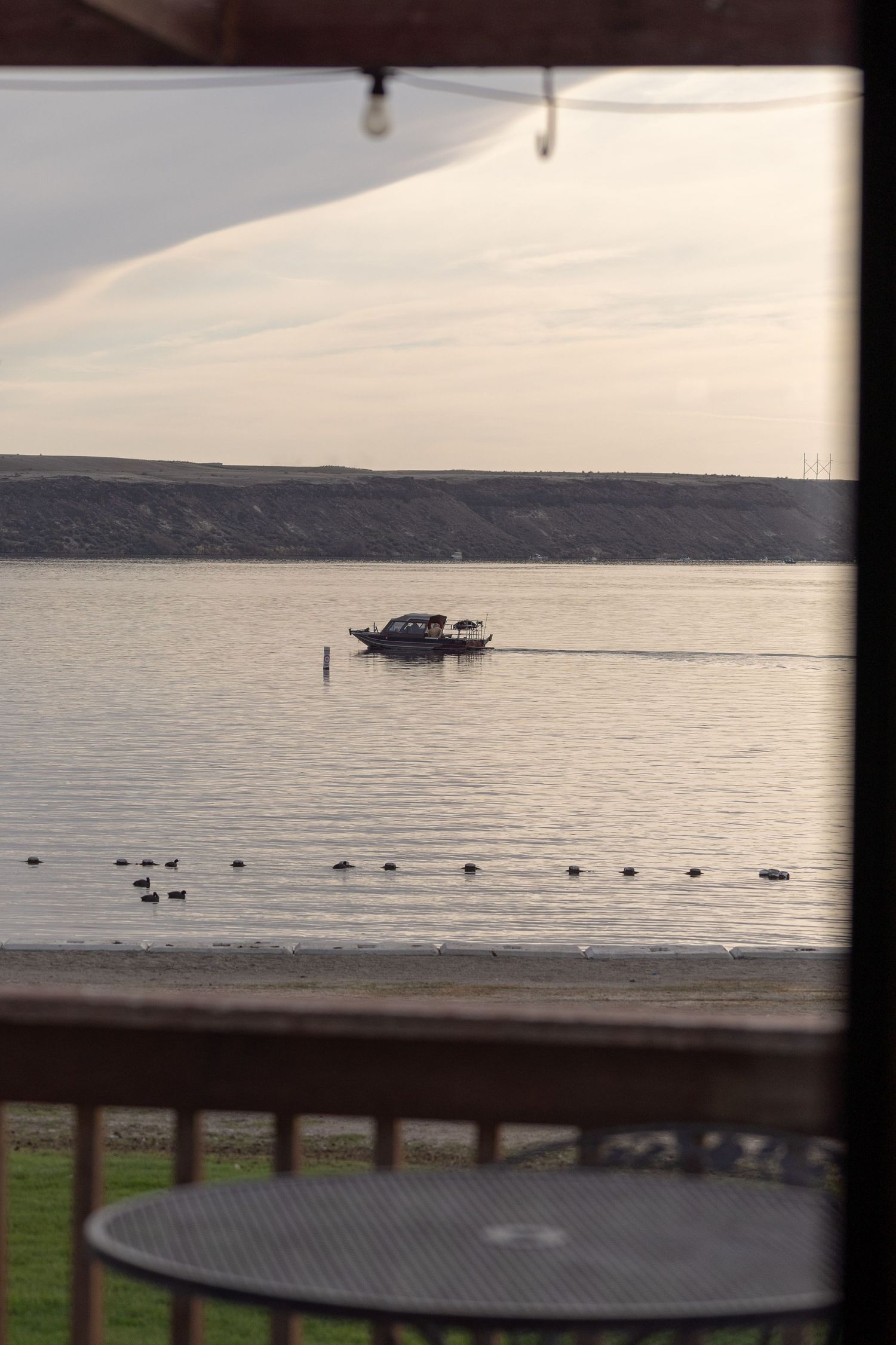 View from Black Sands Resort overlooking a fishing boat on C.J. Strike Reservoir during the Crappie Classic in Idaho