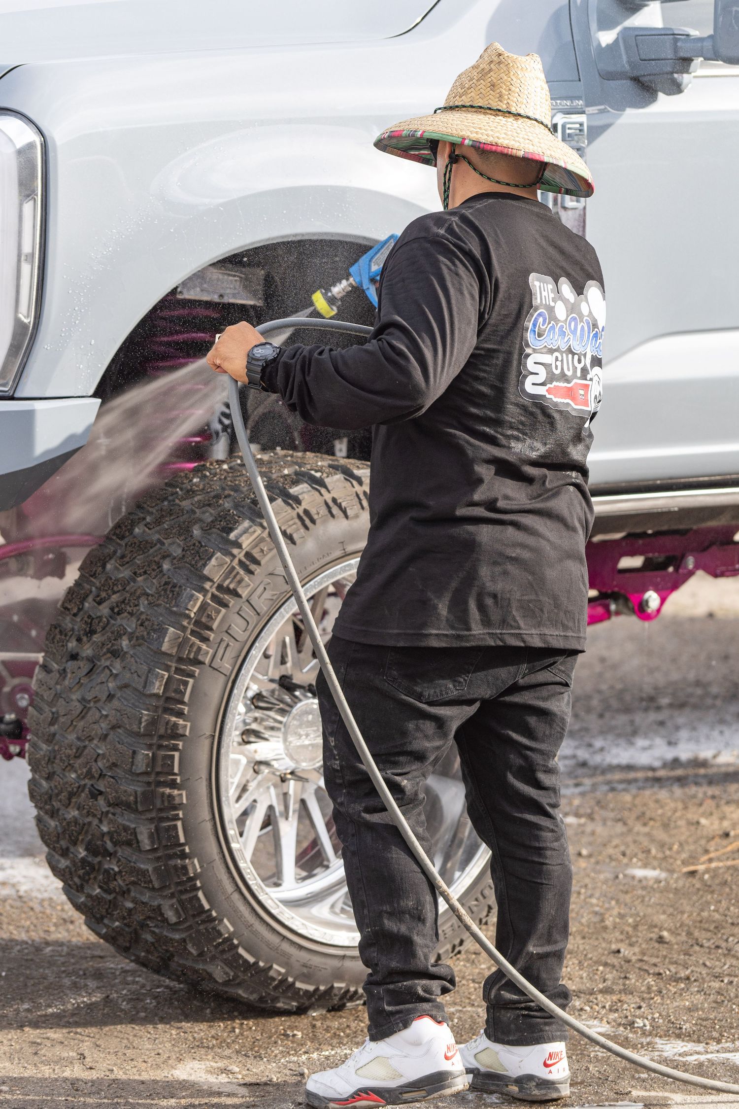 Automotive detailer cleaning a custom truck during Idaho Truck Invasion