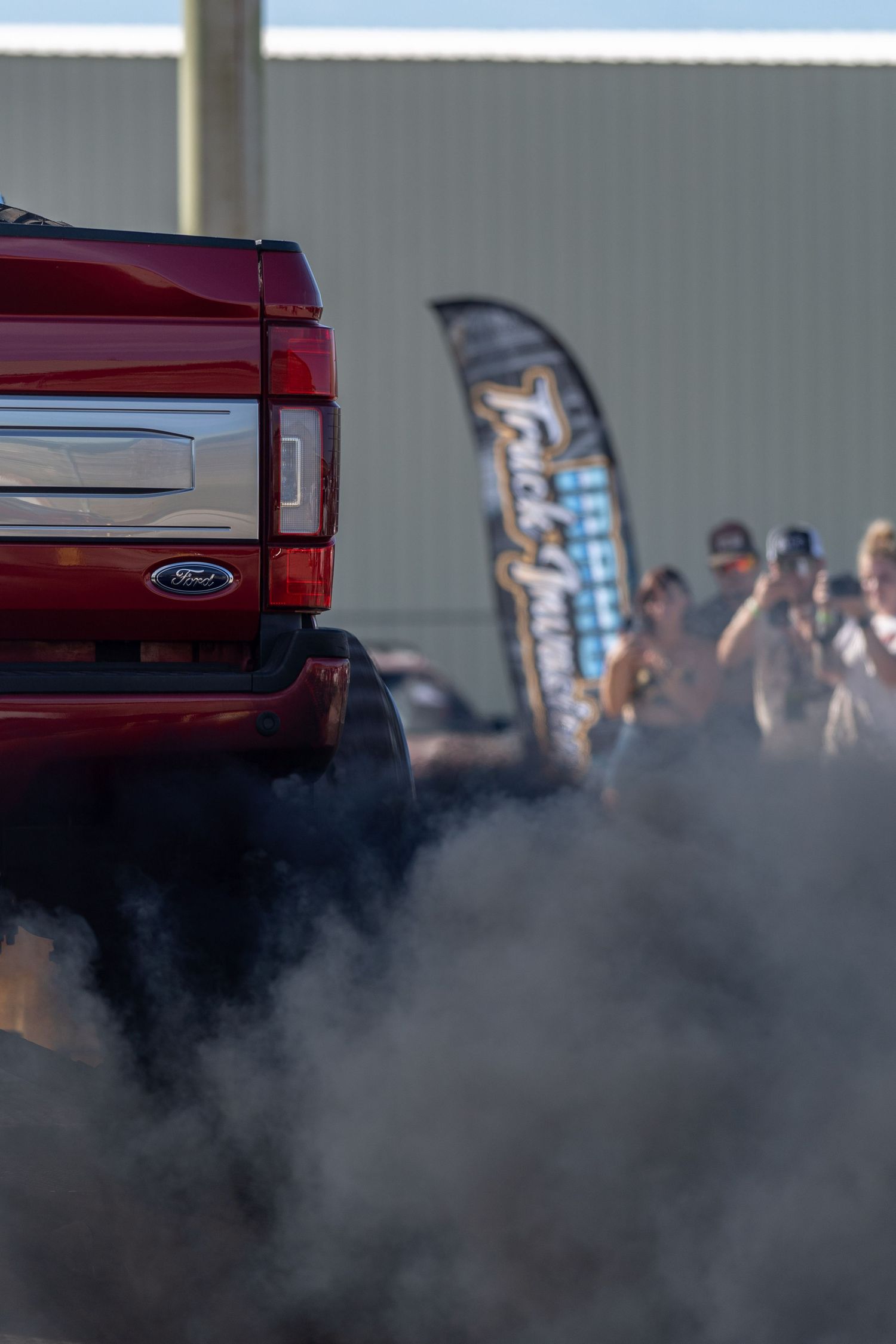 Red custom truck performing a burnout during Idaho Truck Invasion