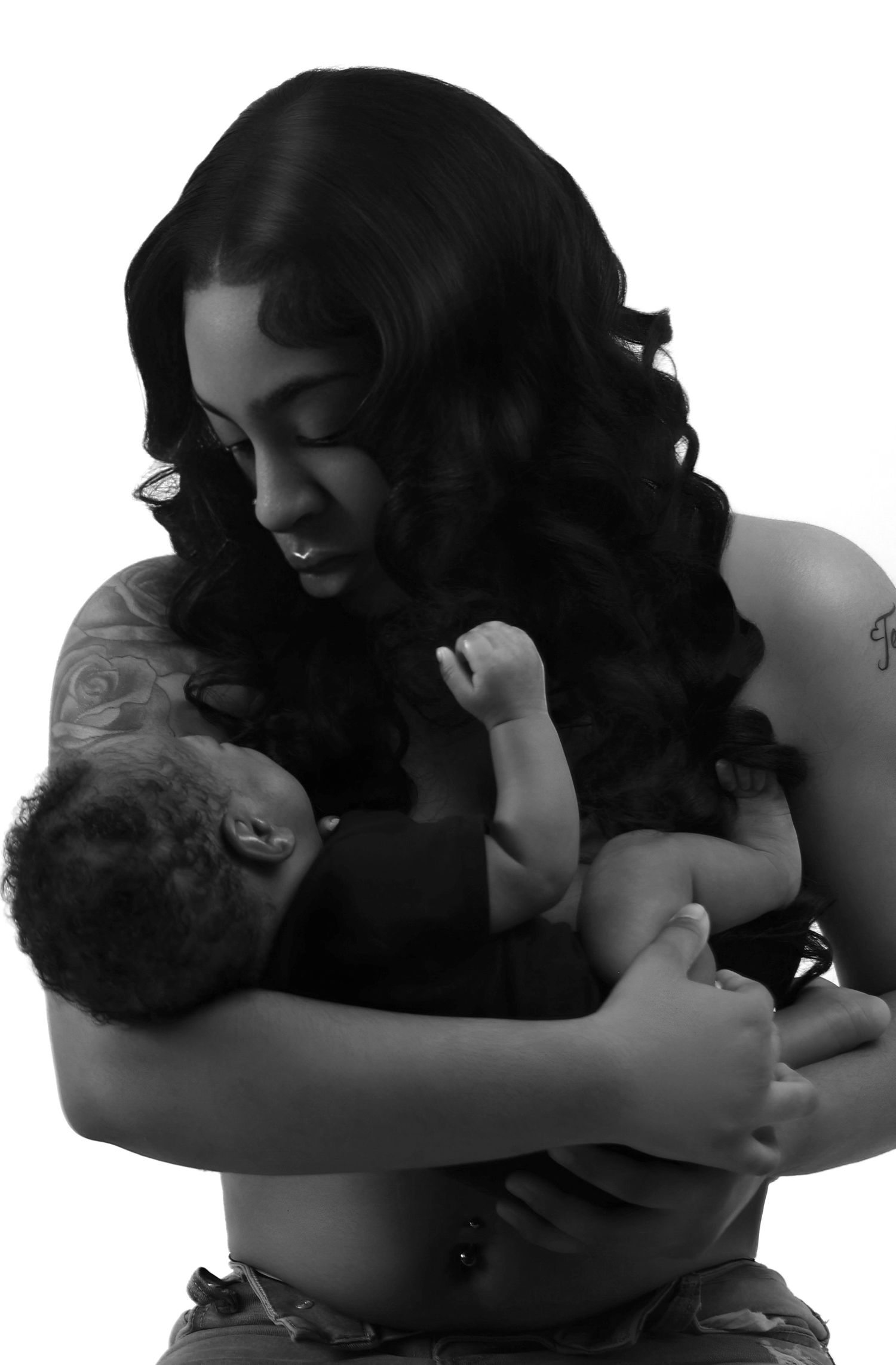 Black and white portrait of a  mother tenderly holding her newborn baby.