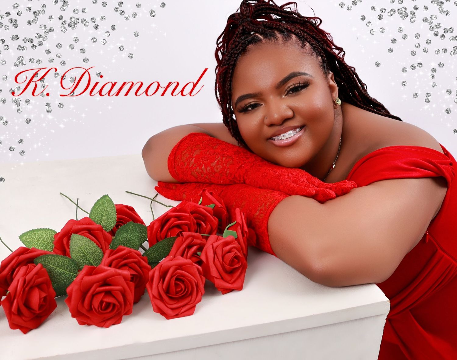 Woman in red dress and gloves poses with red roses in a glamorous portrait with sparkle background and K.Diamond text.