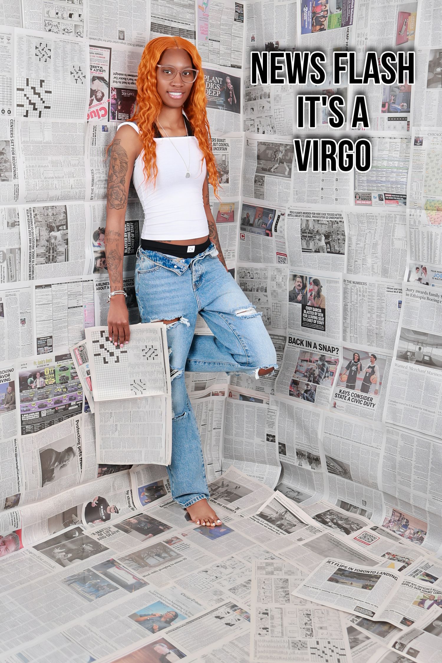Woman with orange hair standing in newspaper-covered room for News Flash Its A Virgo shoot.