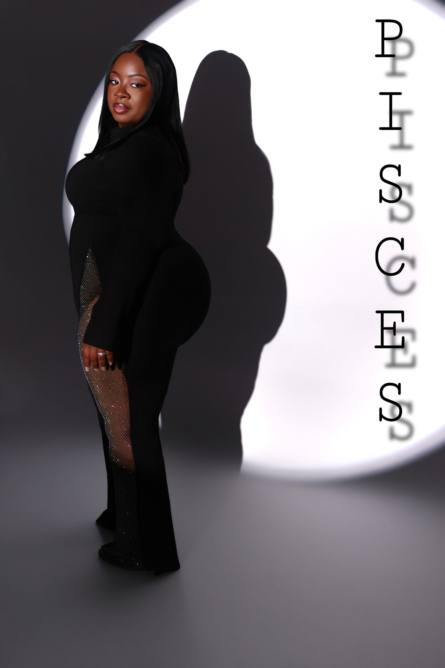 A woman in a black form-fitting gown poses dramatically beside the word PISCES in a spotlight.