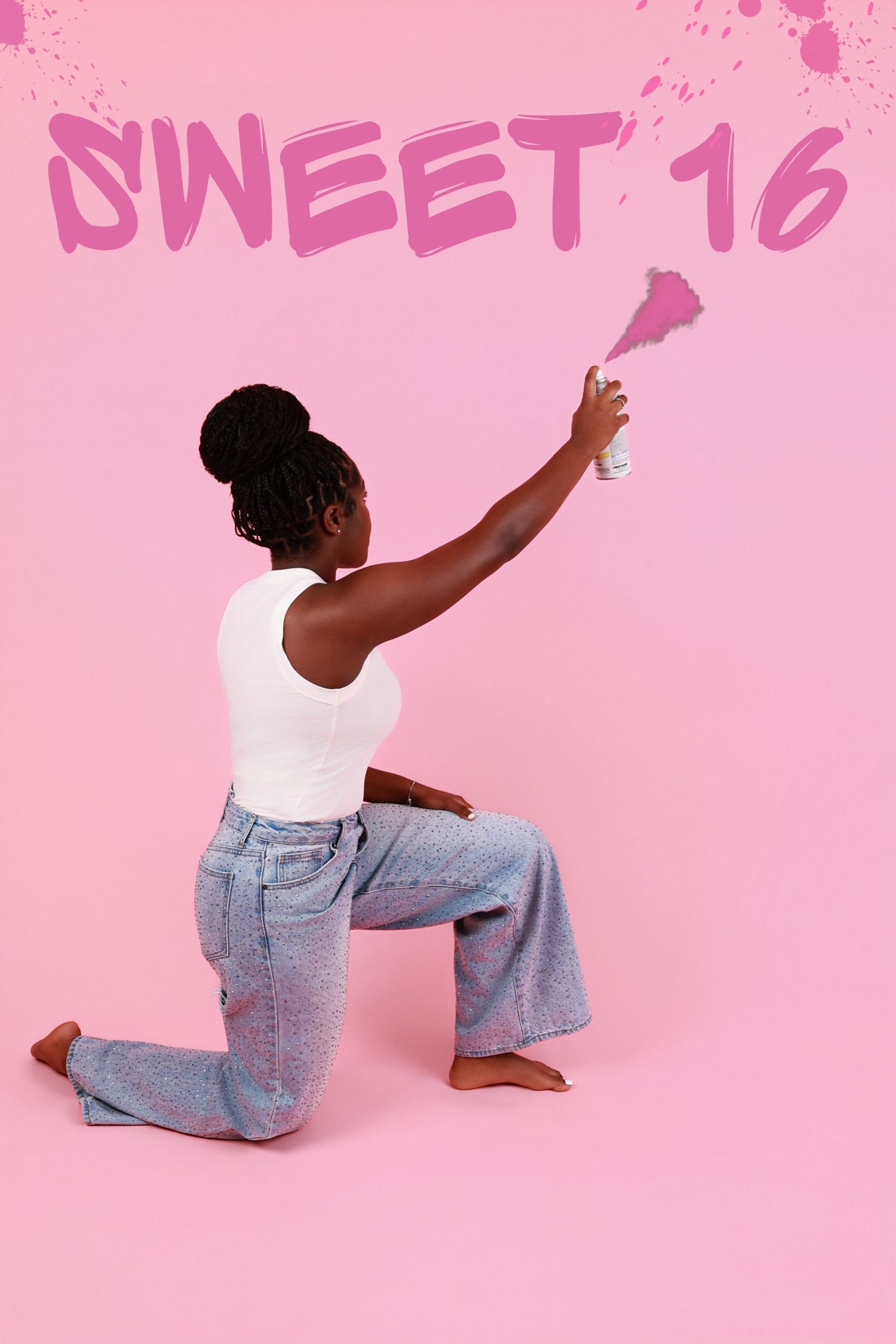 Young woman spray painting pink Sweet 16 graffiti text on a pink background while kneeling.