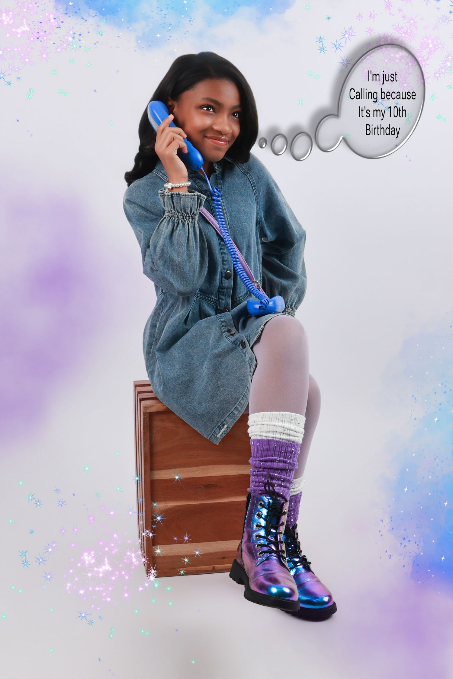 A young girl in a denim dress and iridescent boots celebrates her 10th birthday while talking on a blue phone.