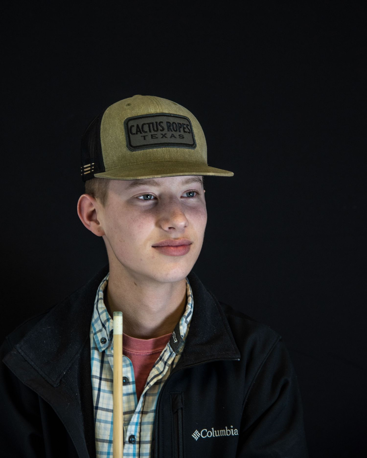 Young man in front of a black background