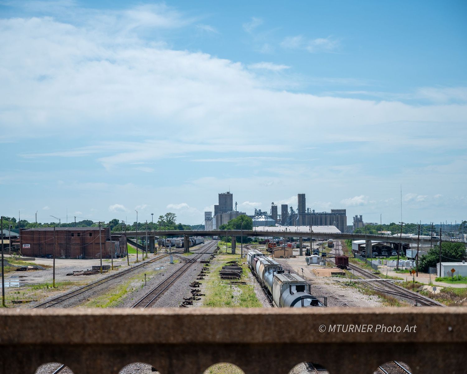 View of train yard as seen from a road overpass.