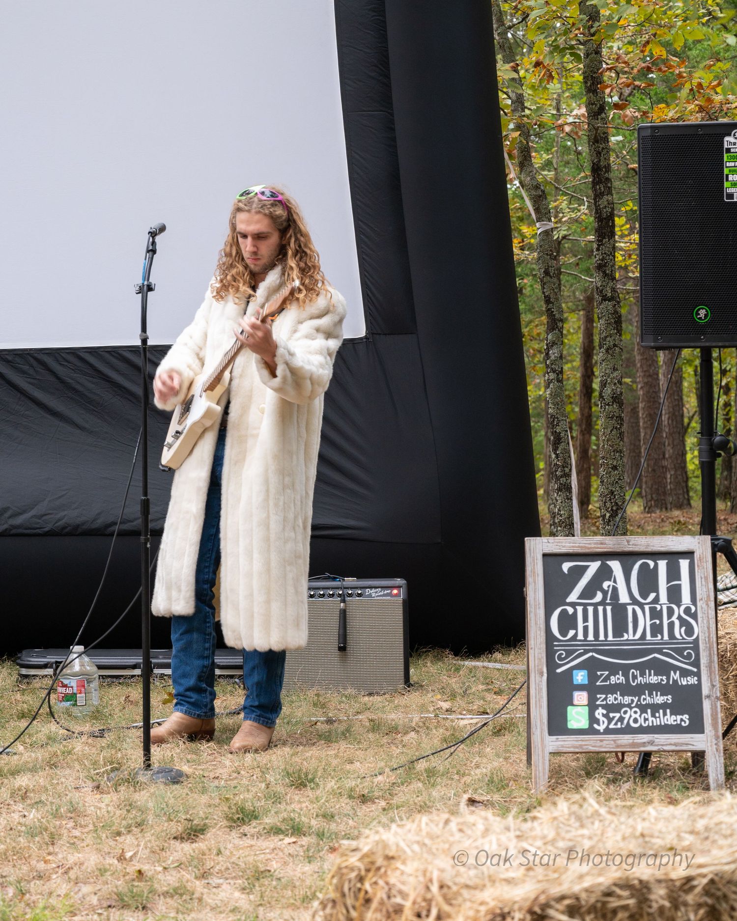 Singer/musician performing at an outdoor event.