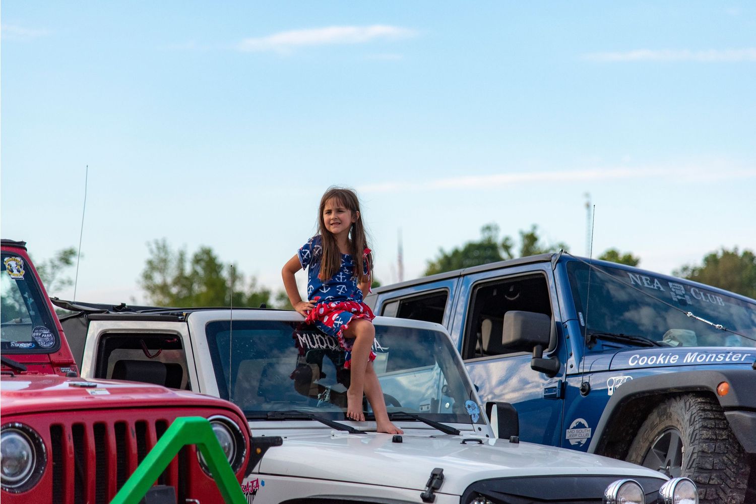 young girl sitting on a Jeep