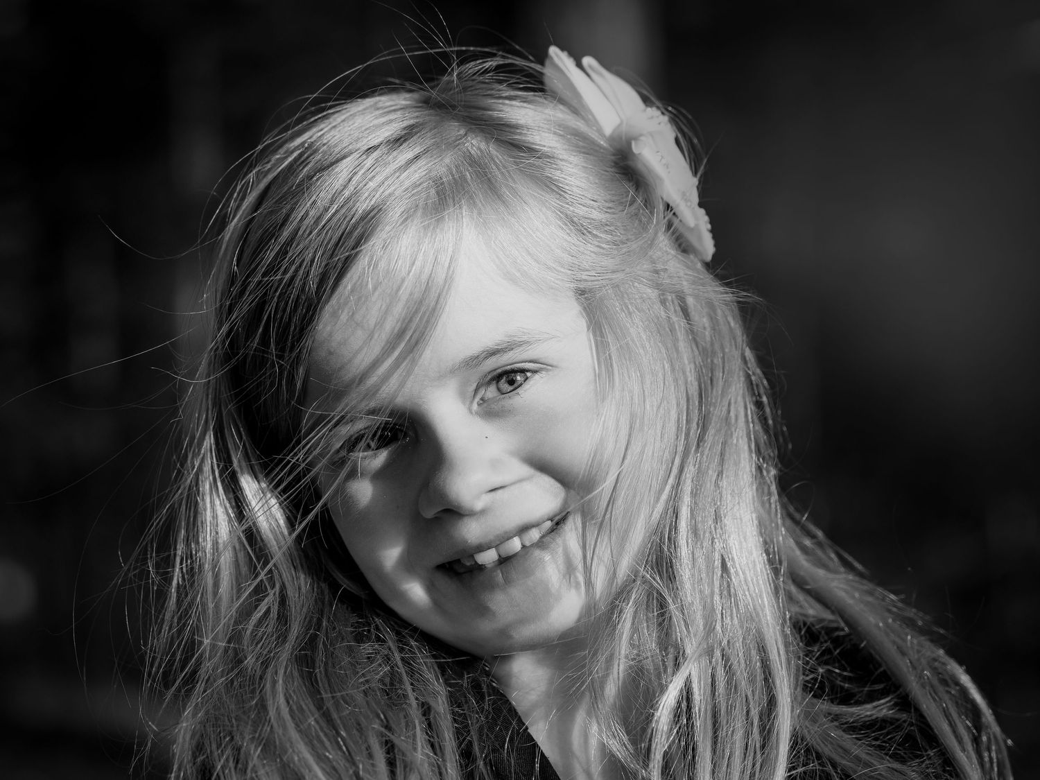 A black and white photo sequence shows a person's hair flowing freely in a dynamic motion.