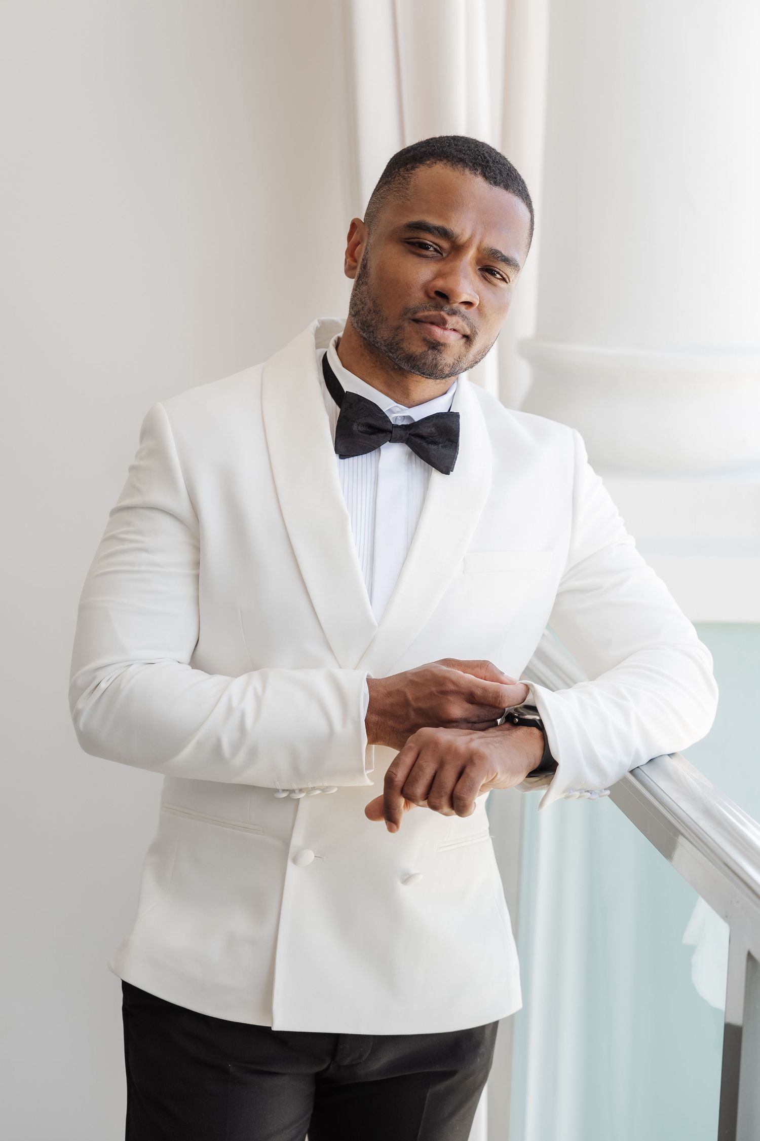 Grooms portrait wearing white dinner jacket with black pants photographed by PhotoMagic Jamaica Olga sam