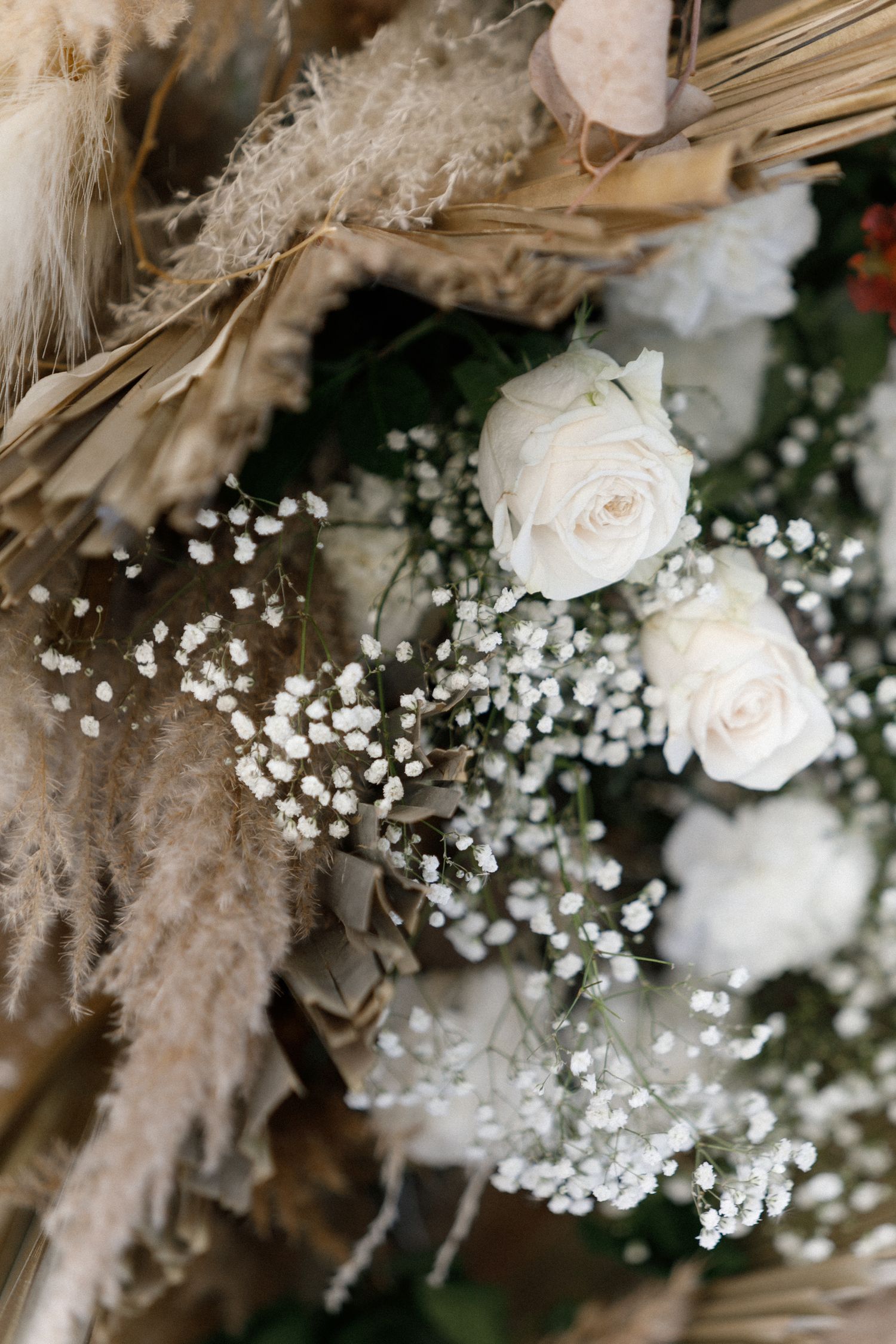 Delicate white roses and baby's breath flowers create an ethereal wedding bouquet arrangement.