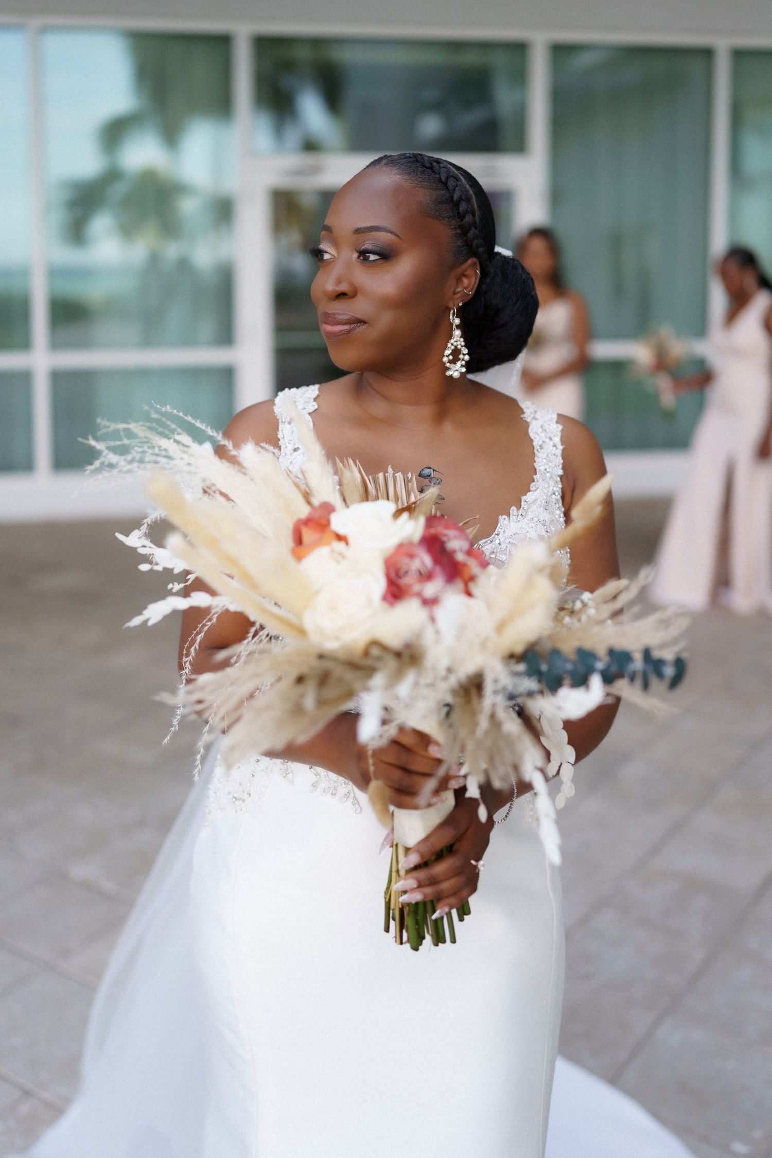 Elegant bridal portrait with a stunning dried floral bouquet featuring pampas grass and roses.