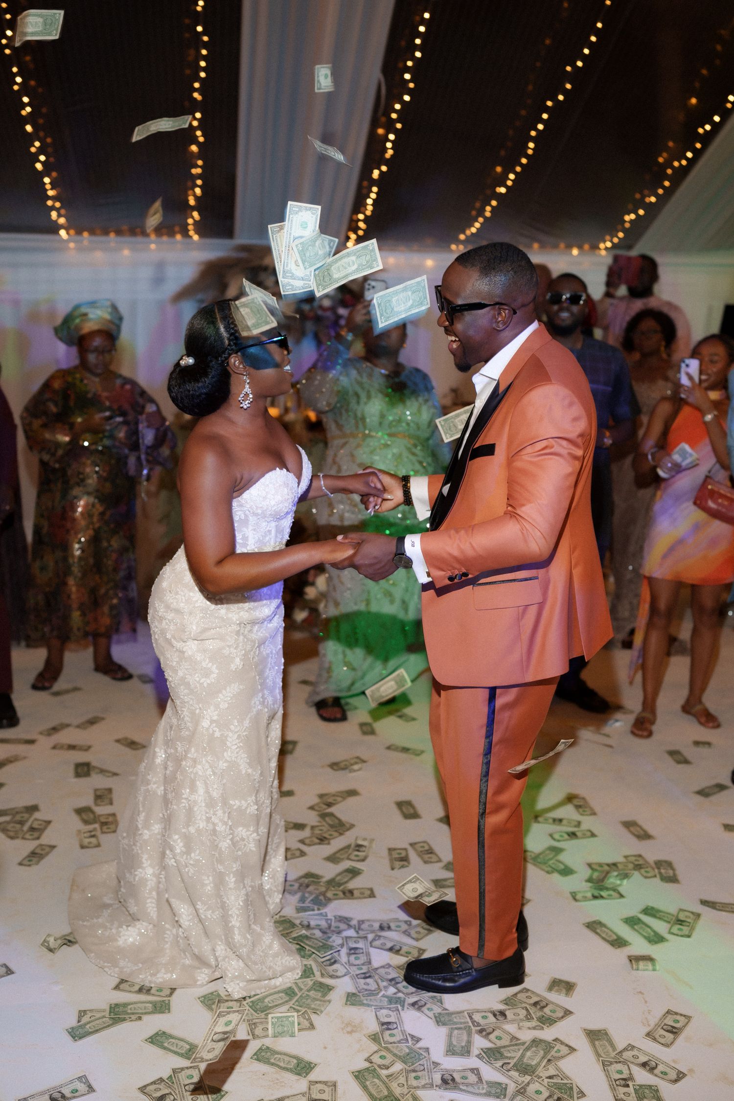 Wedding dance floor celebration with money being thrown in the air during reception.