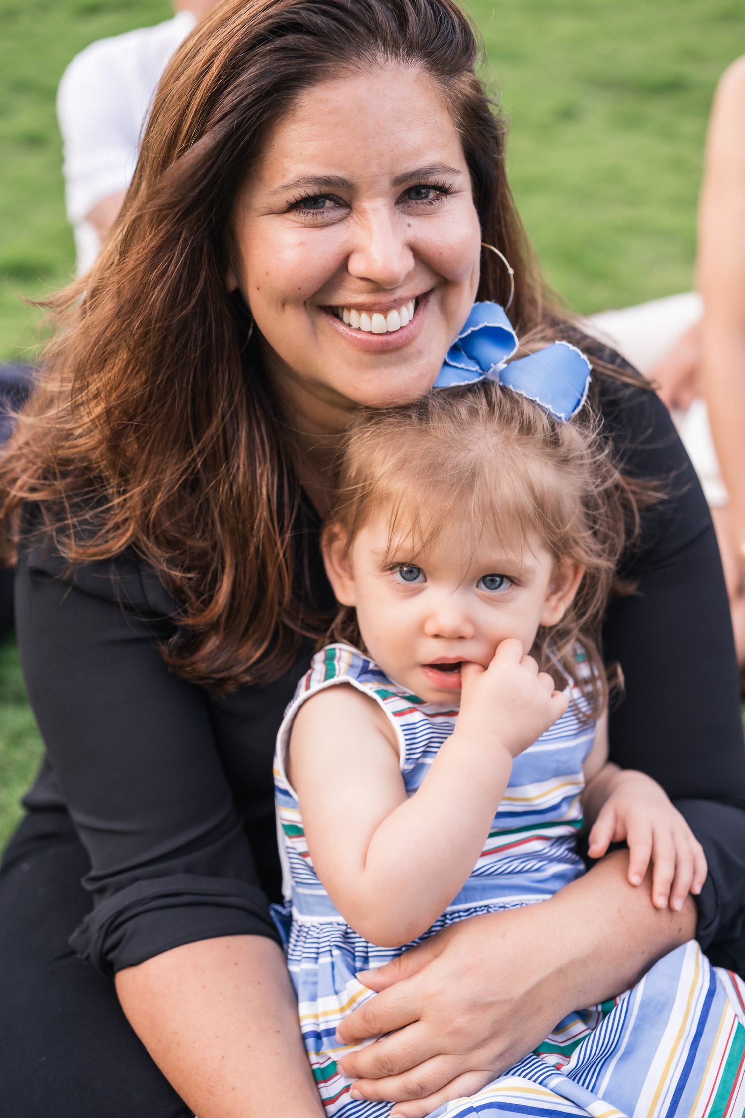 Heartwarming outdoor portrait against green grass background.