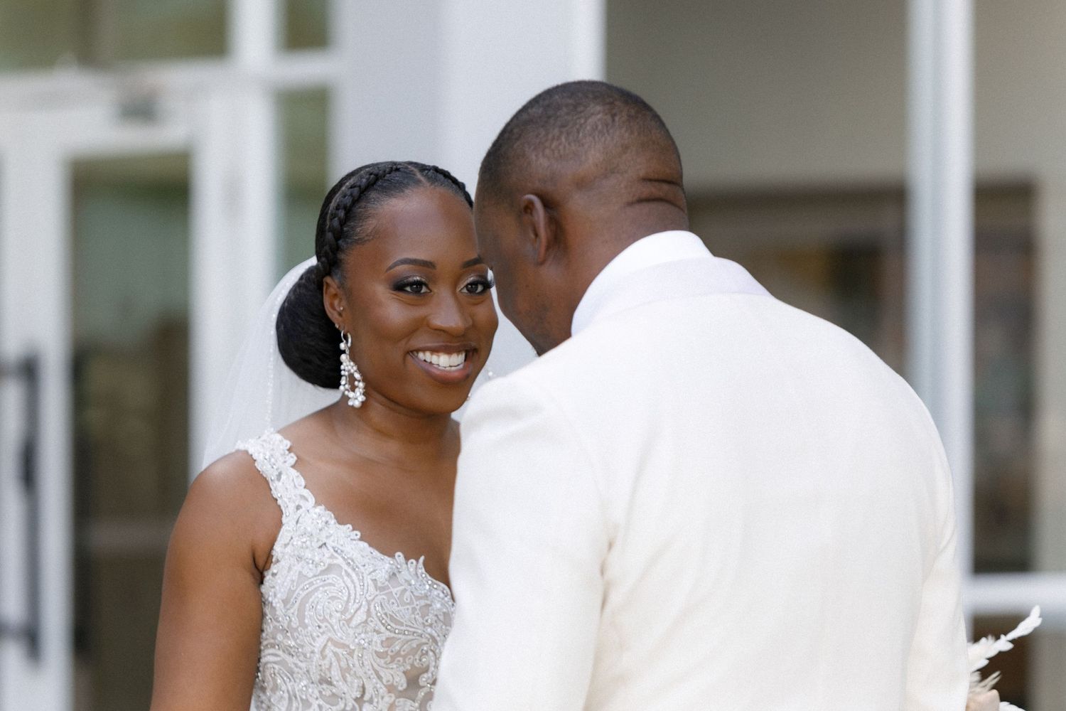 Intimate moment between newlyweds during first look outside venue.