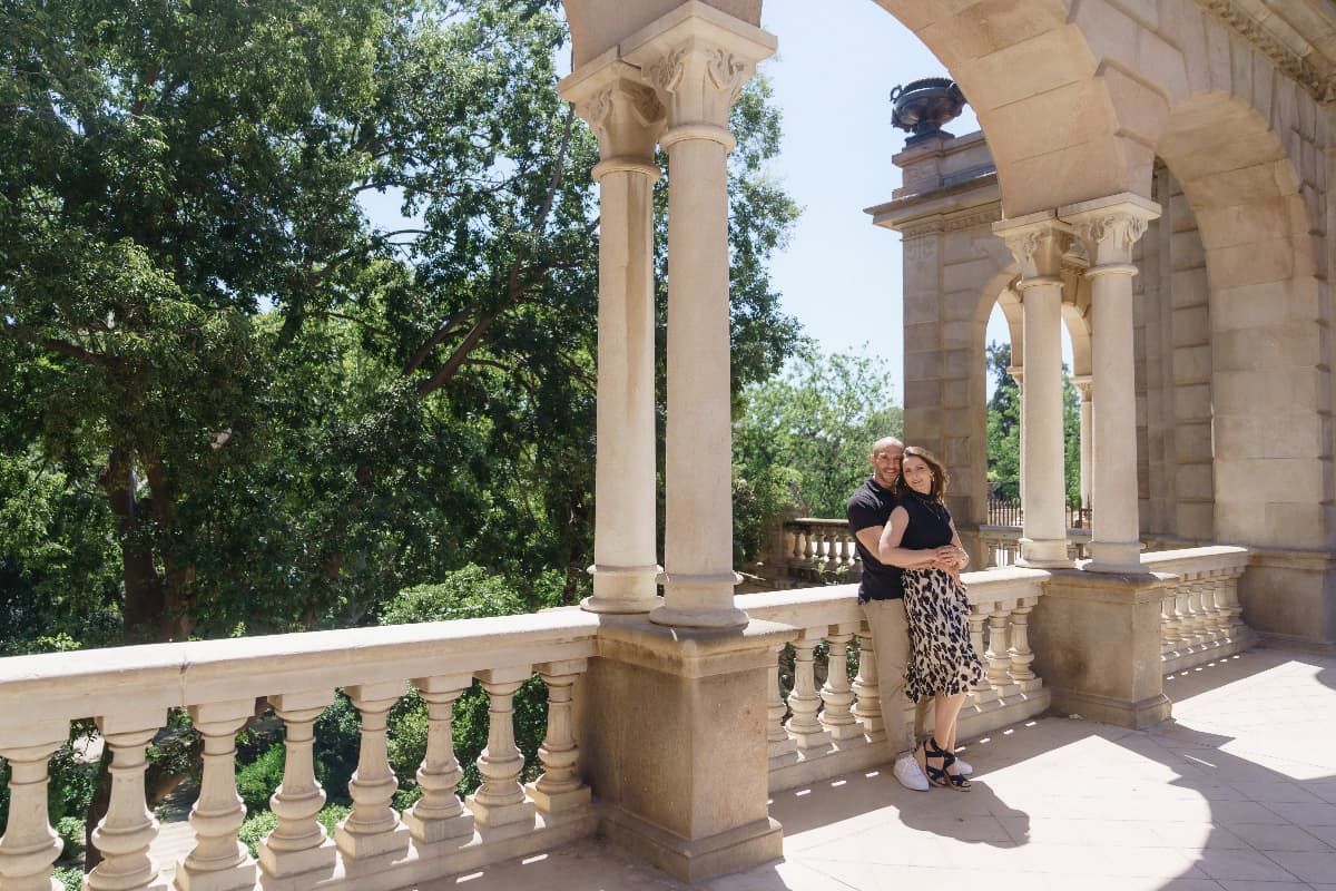 A couple posing smiling and hugging for a photoshoot in Ciutadella Park Barcelona