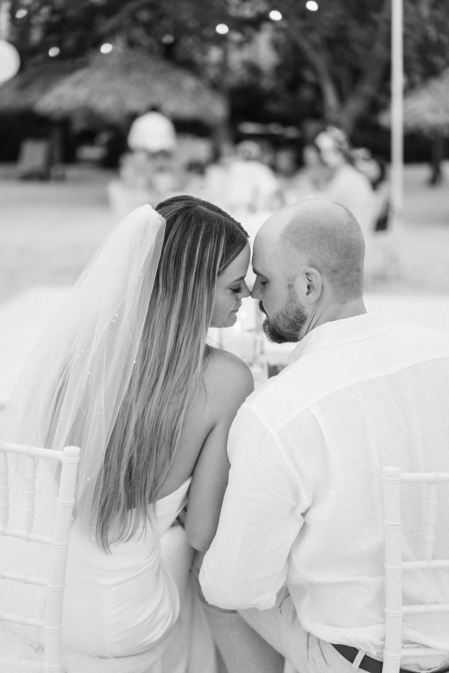 An intimate black and white wedding moment captured outdoors.