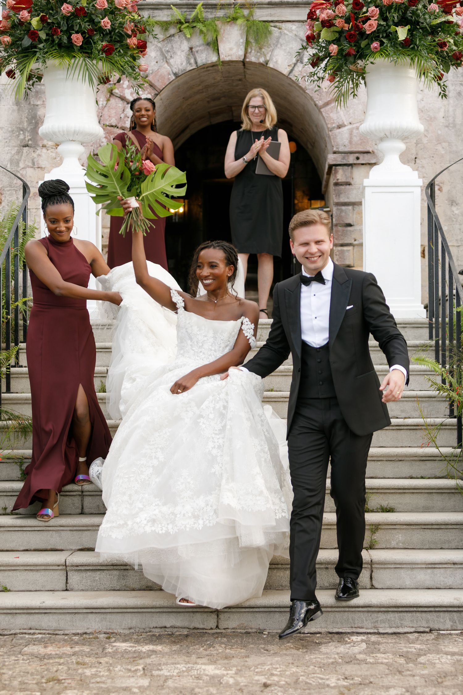 Newly wed couple going down the steps at the historic Rose Hall venue photographer by Olga Sam wedding photographer in Montego Bay Jamaica