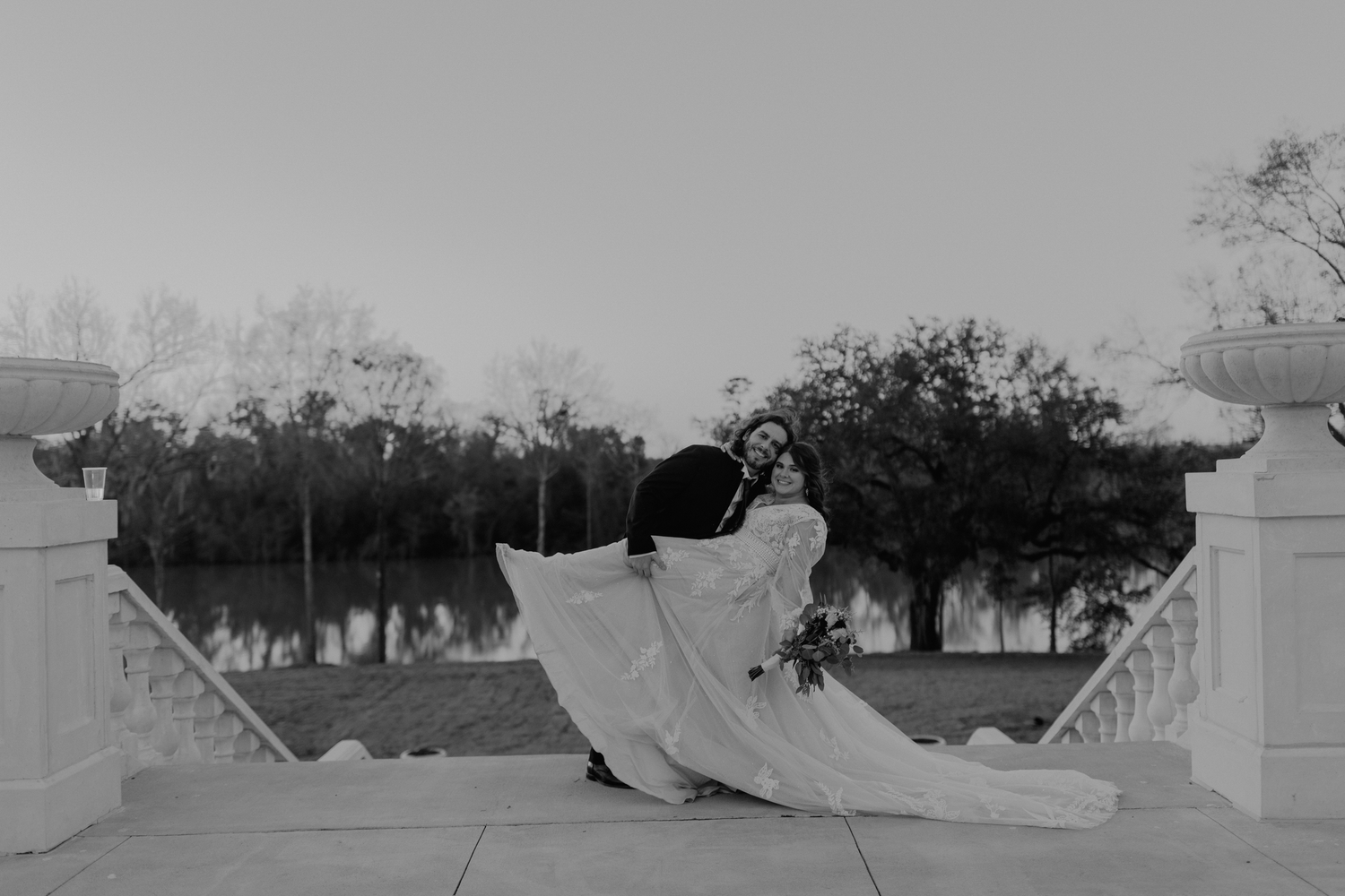 Dramatic black and white photo of bride's dress flowing between pillars.

Georgia-based wedding and elopement photographer traveling through